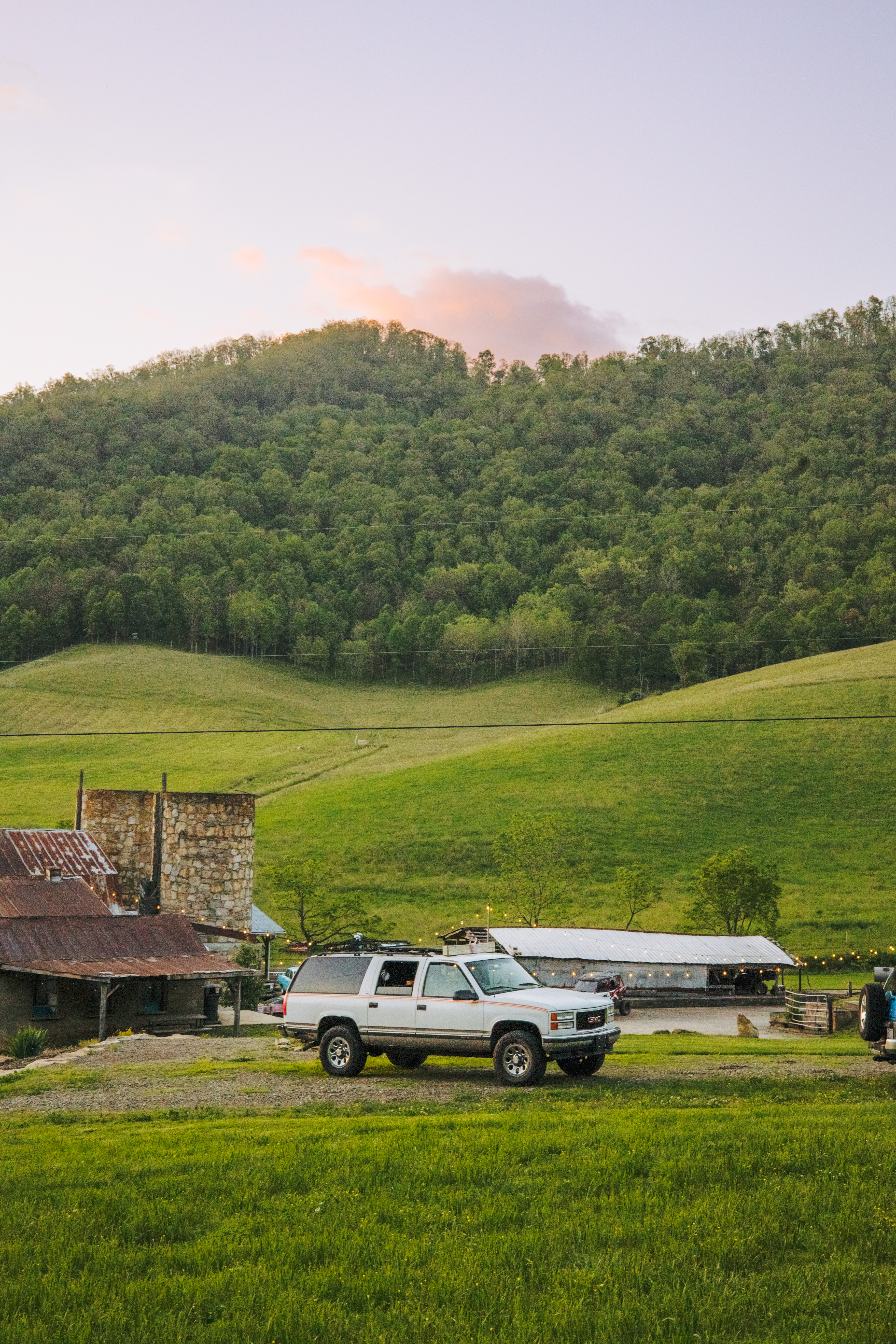 My truck camper sitting at the site at sunset. 