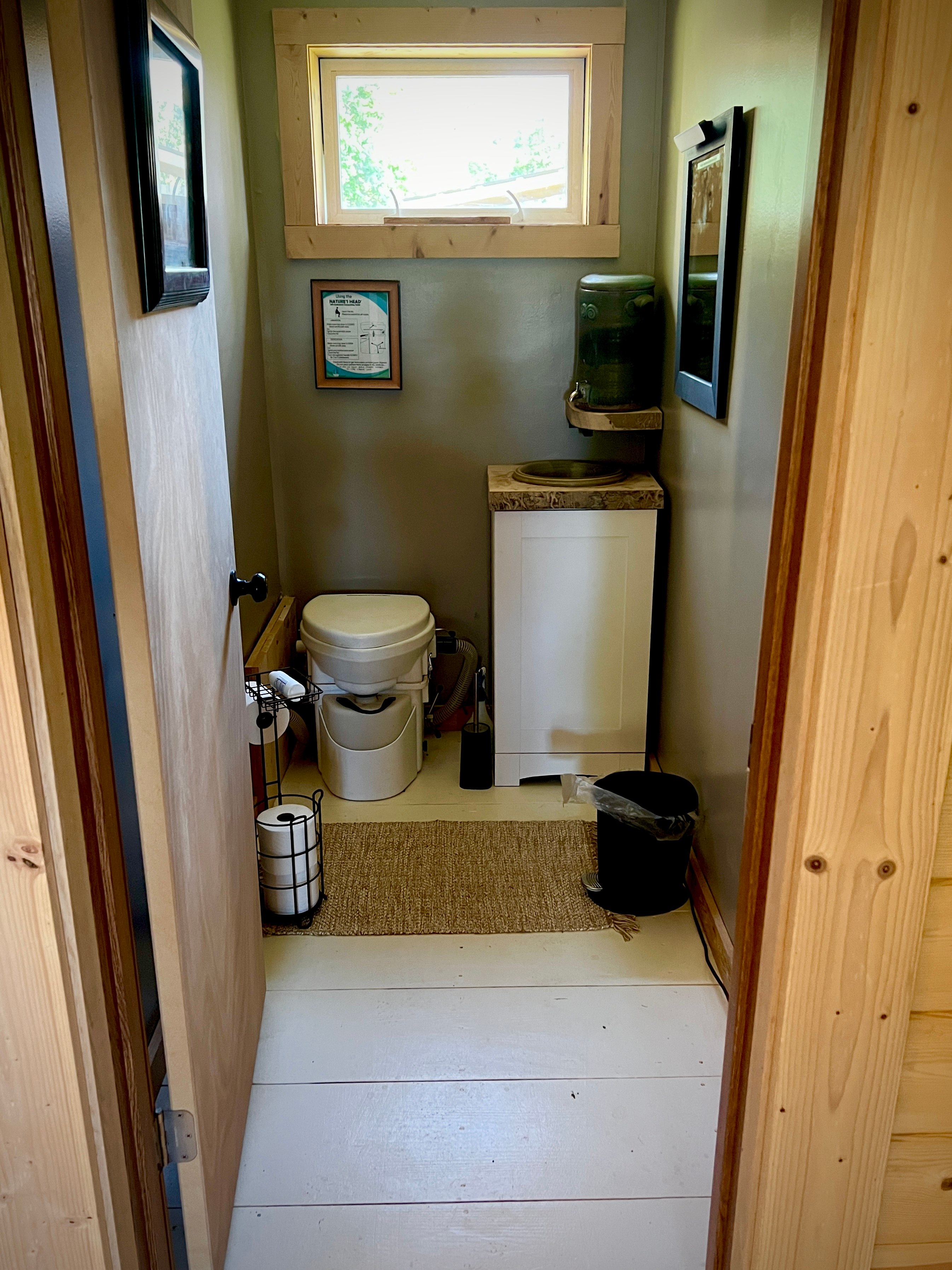This is a green bathroom with a top line composting toilet.

