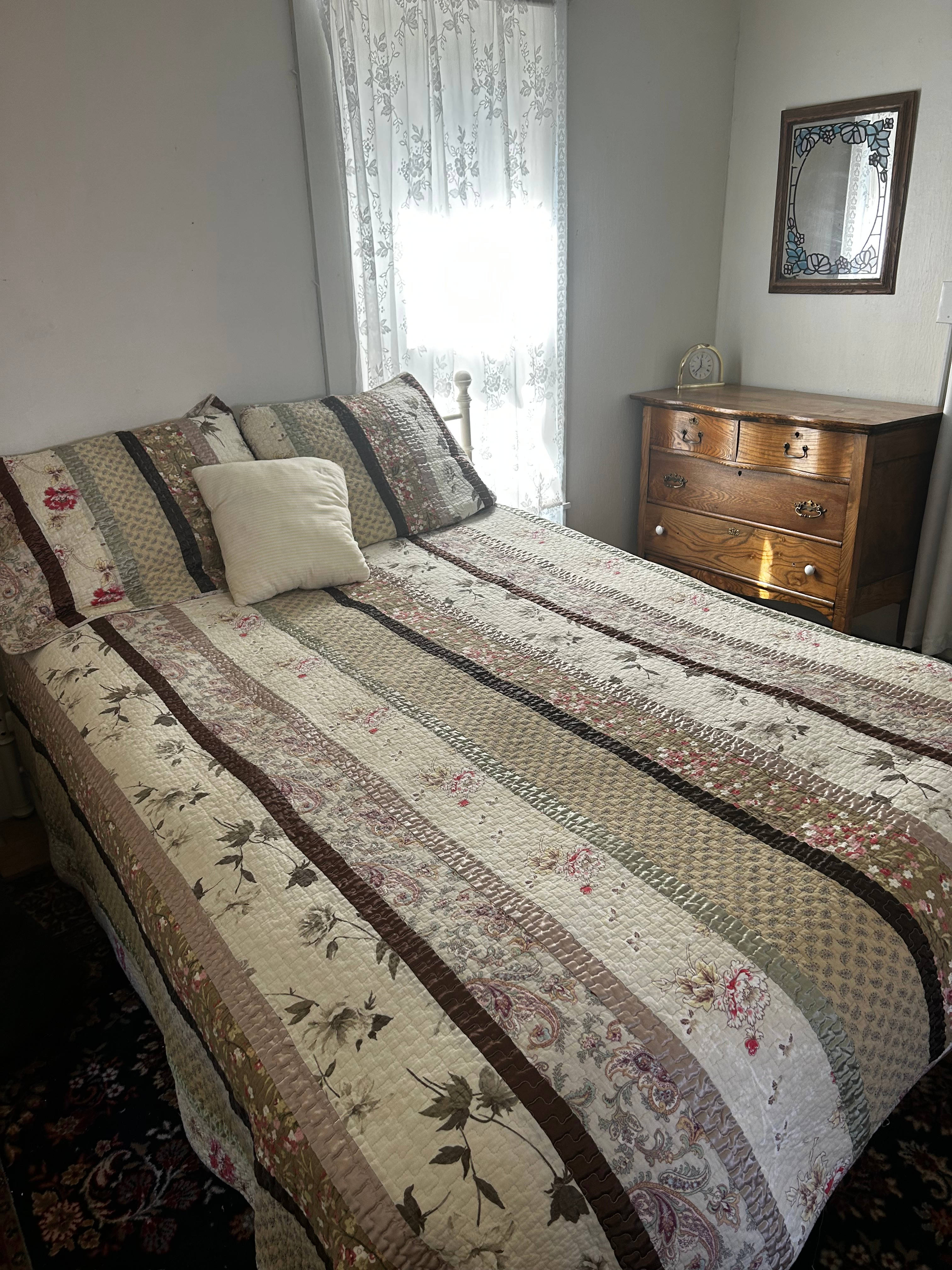 The bedroom sleeps two in this queen bed and is located in the rear of the house. 