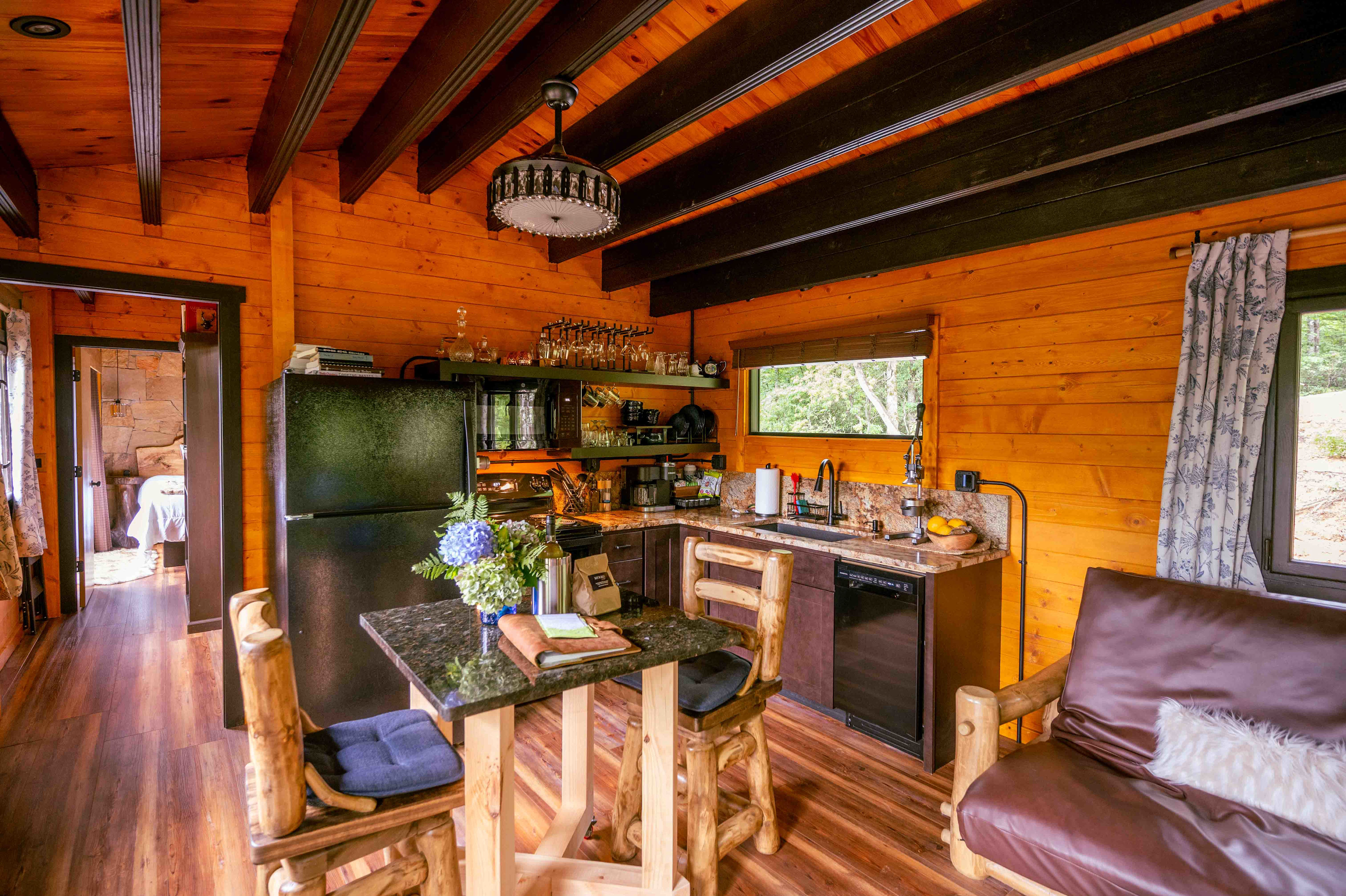 Overview of the kitchen and part of the den space. Down the short hallway is the bathroom and bedroom.