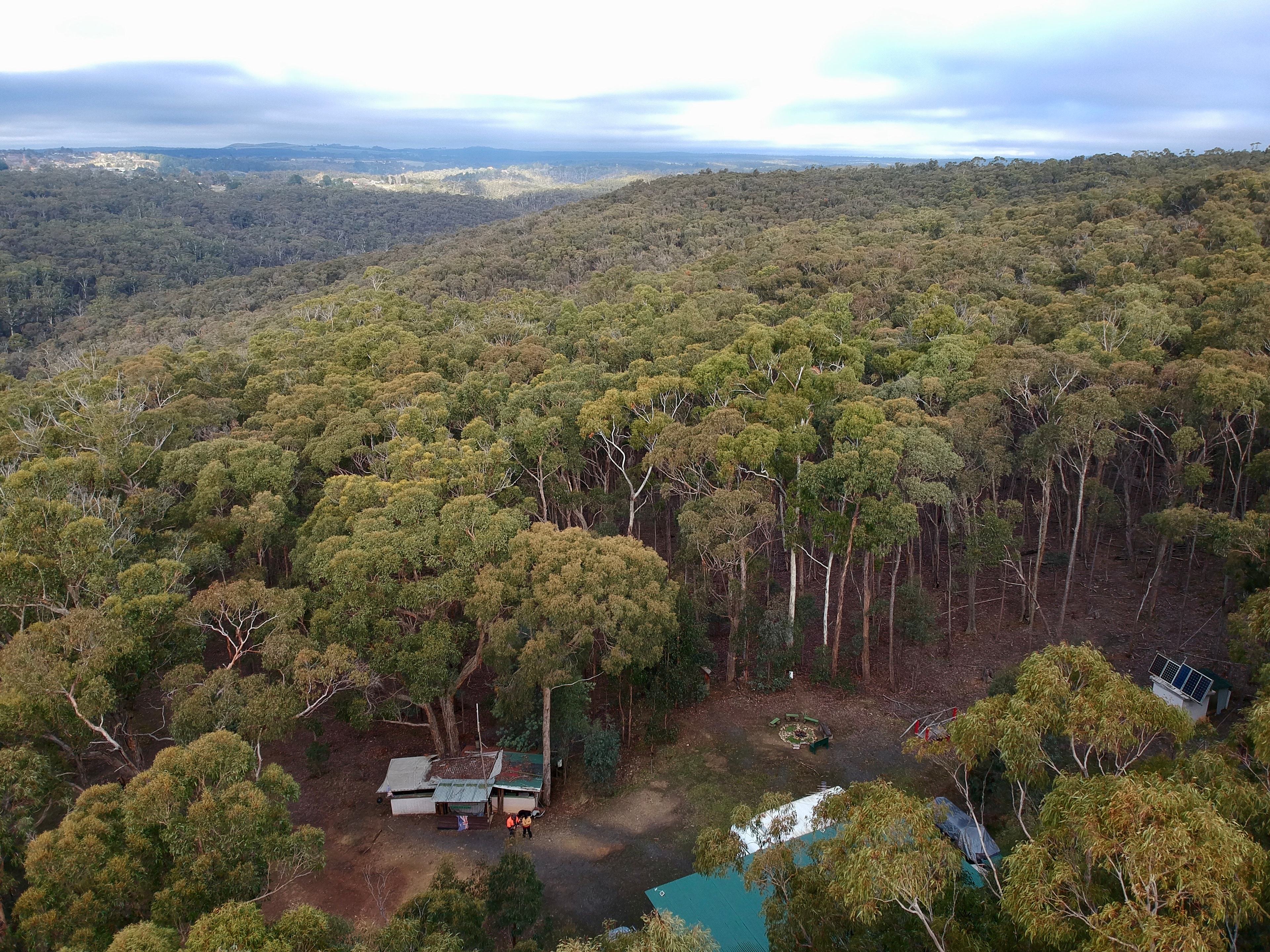 Aerial view showing fire pit, shelter (green roof) and view to Daylesford township top left