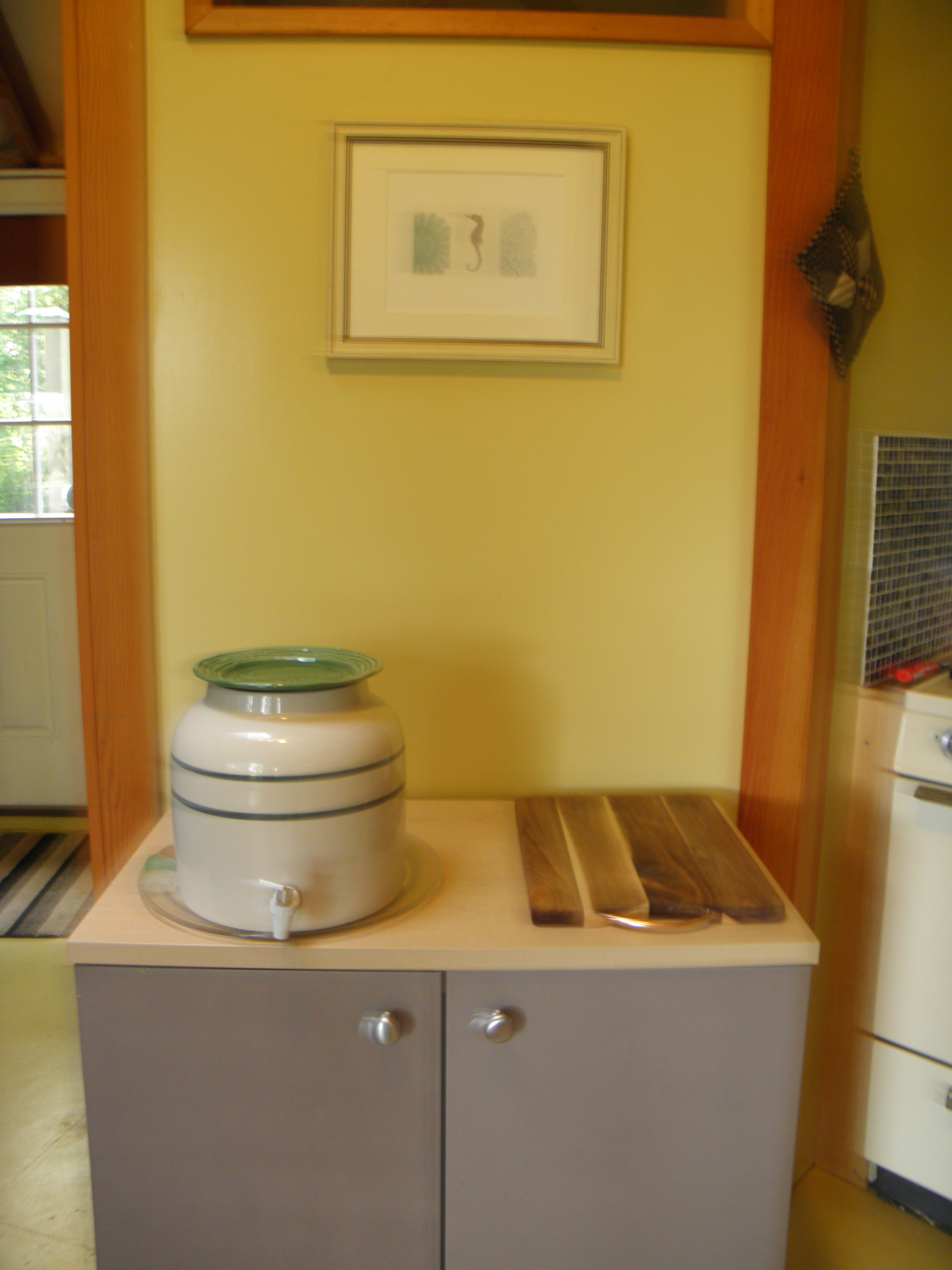 The tap water is from our well that has a bit of iron in it, so filtered drinking water is provided in this crock, with more below in the cabinet.