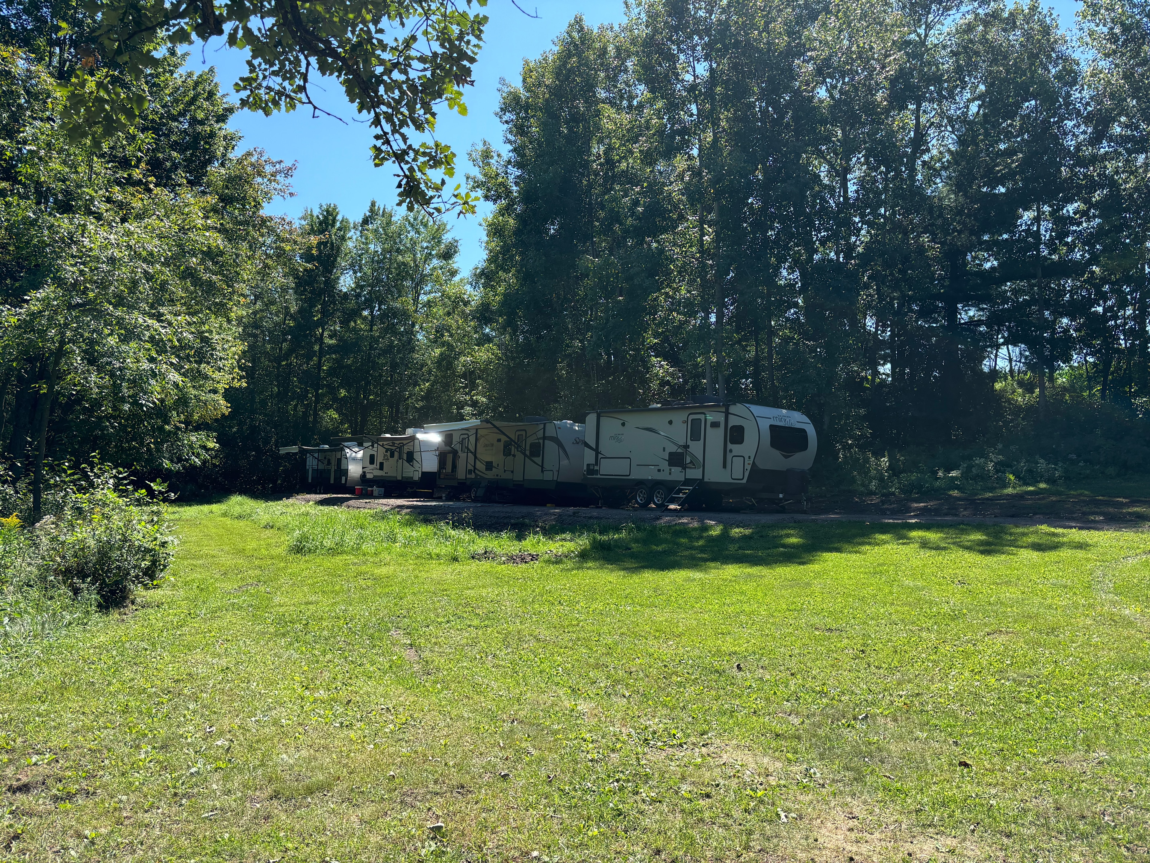 New gravel pad put in 2024 with electric hookups for 4 campers (30-amp each).
