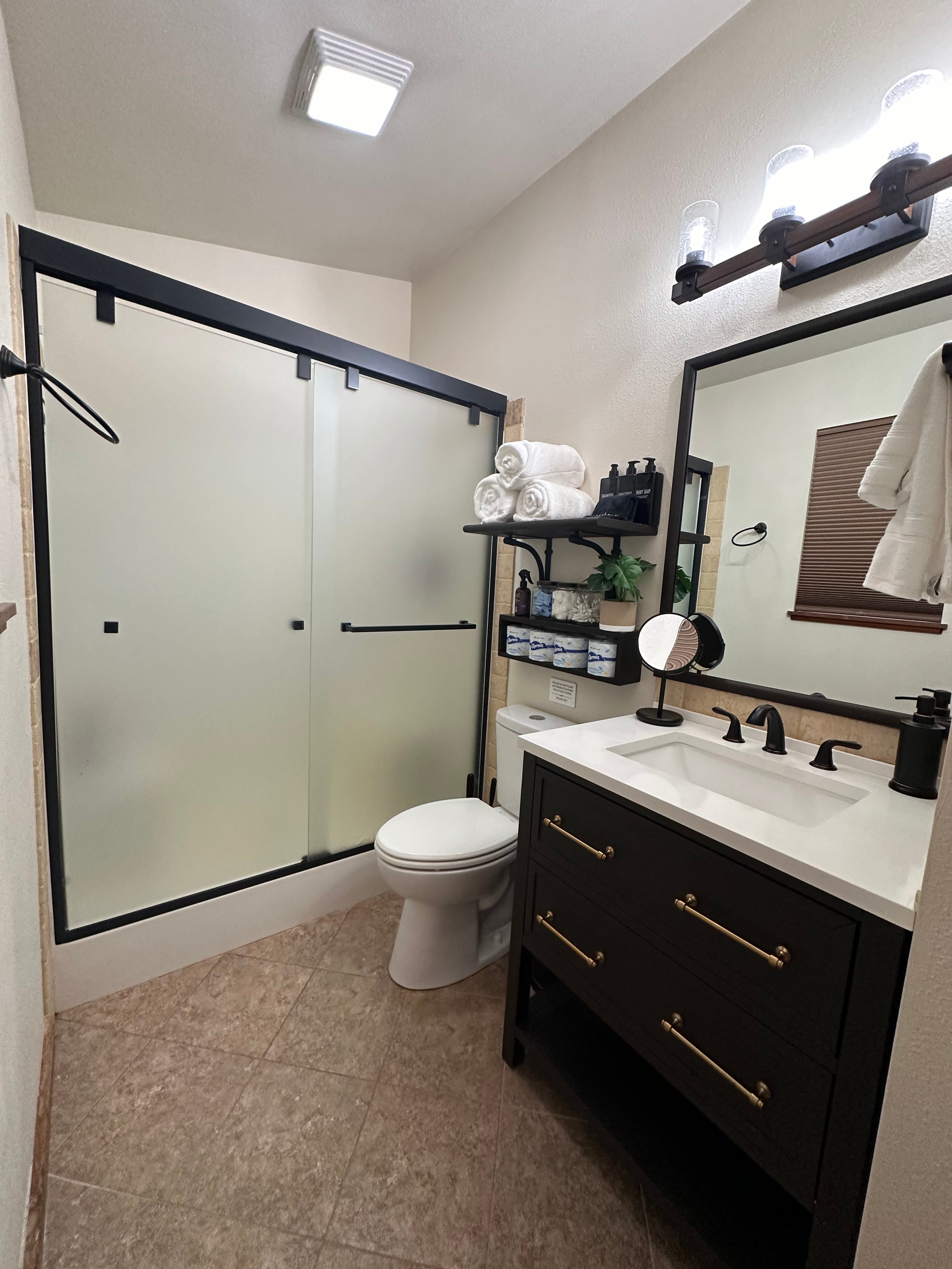 Private bathroom, shower, vanity, and toilet with many other amenities.