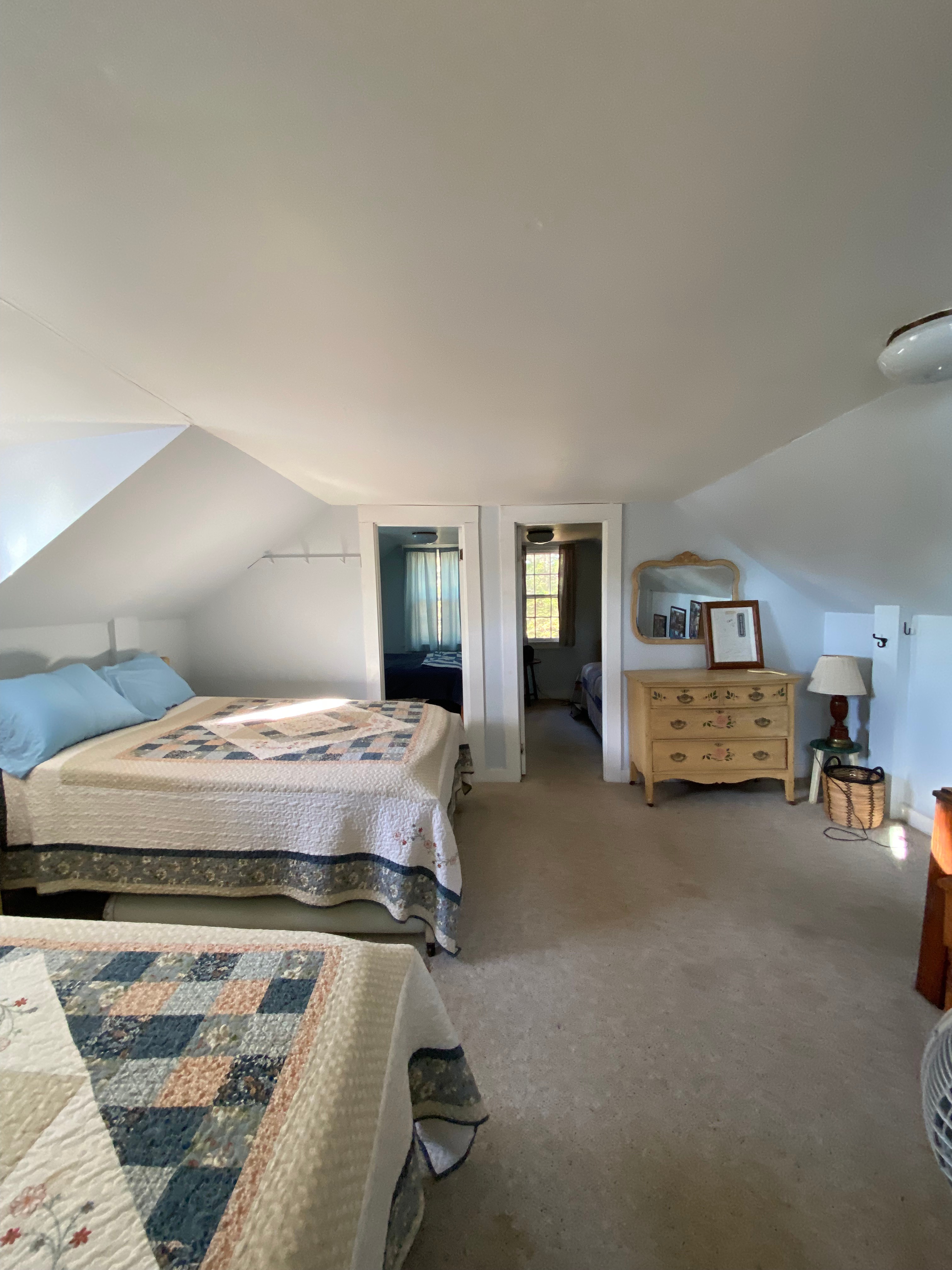 Upstairs loft ft. two closed door bedrooms: "Front Room" (left) & "Back Bedroom" (right). All w/ full sized mattresses. 