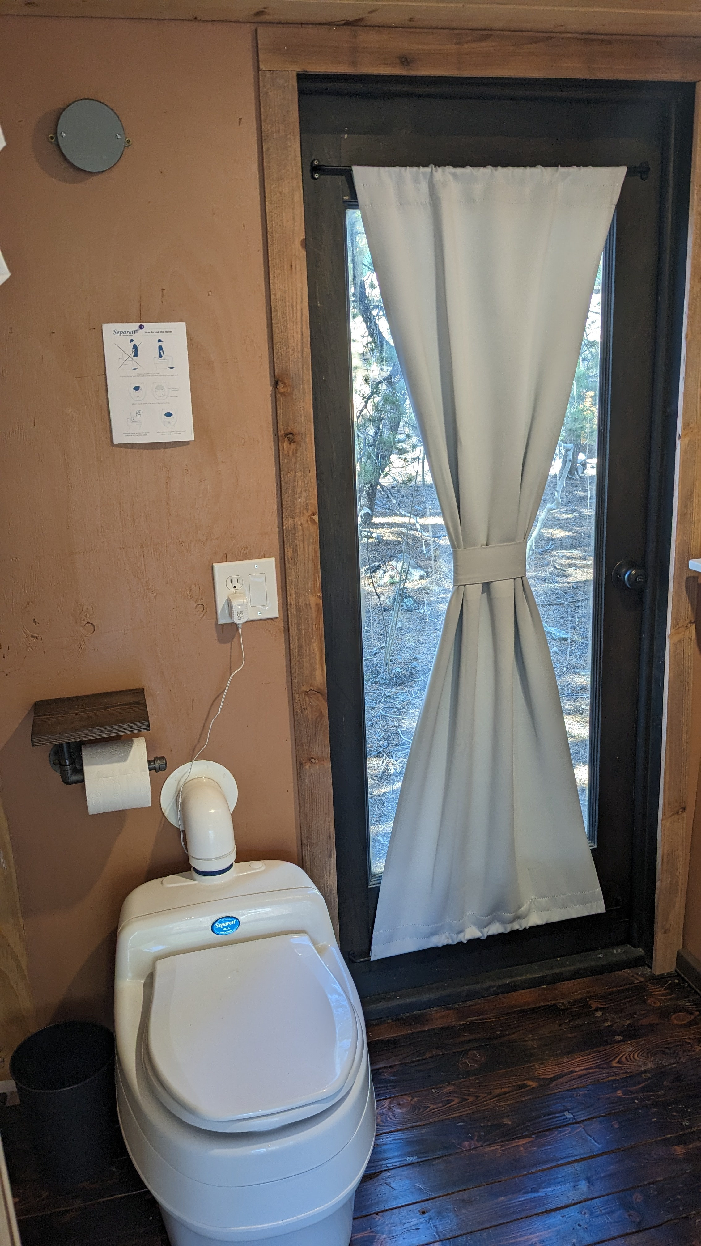Composting toilet. It has a urine diverter, and electric fan/vent which keeps it sanitary and smell-less. 
