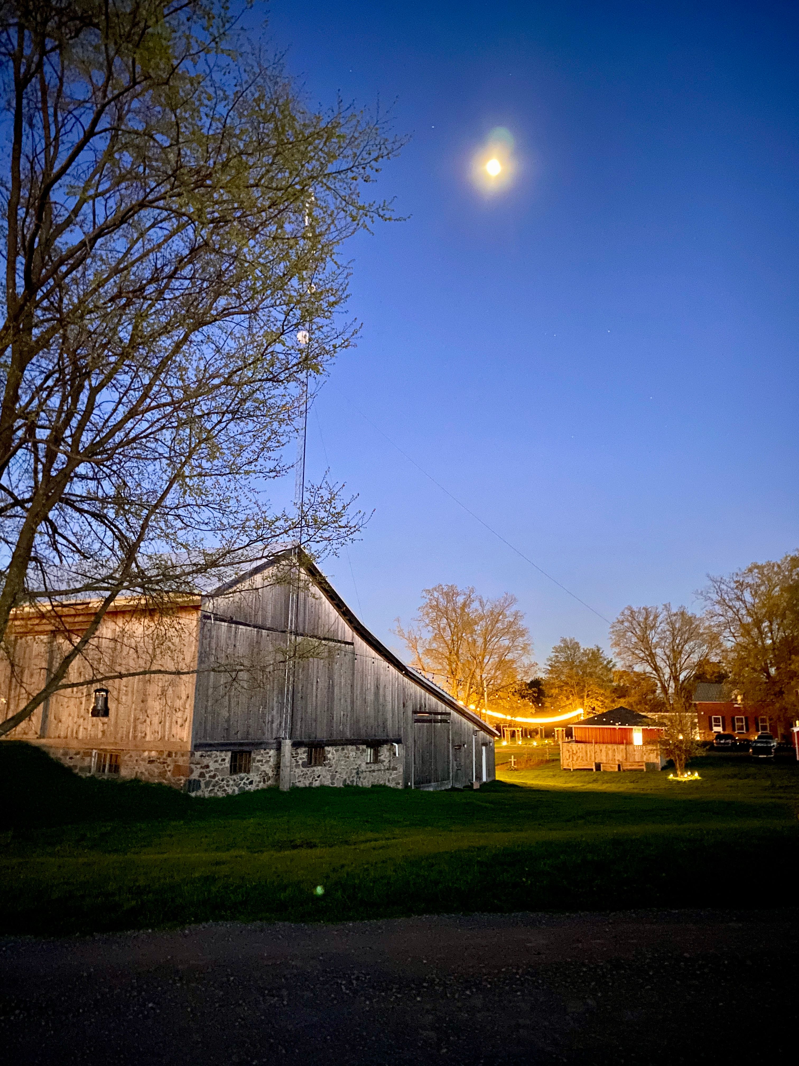 Moon and stargazing at night over the barn