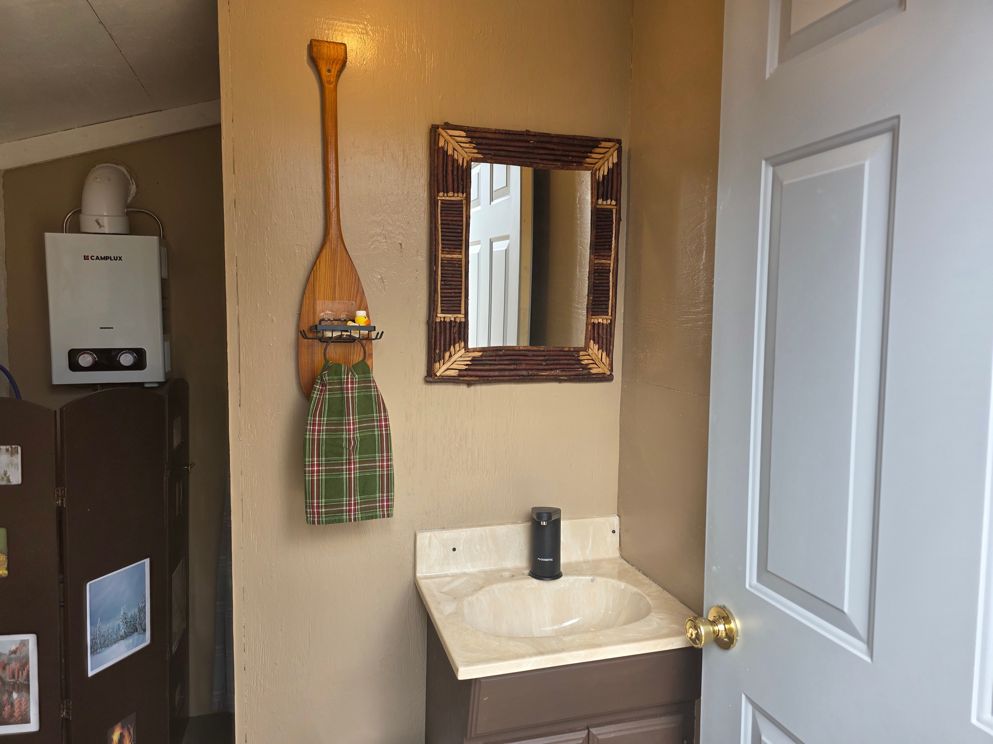 Outhouse/On demand water heater for shower.