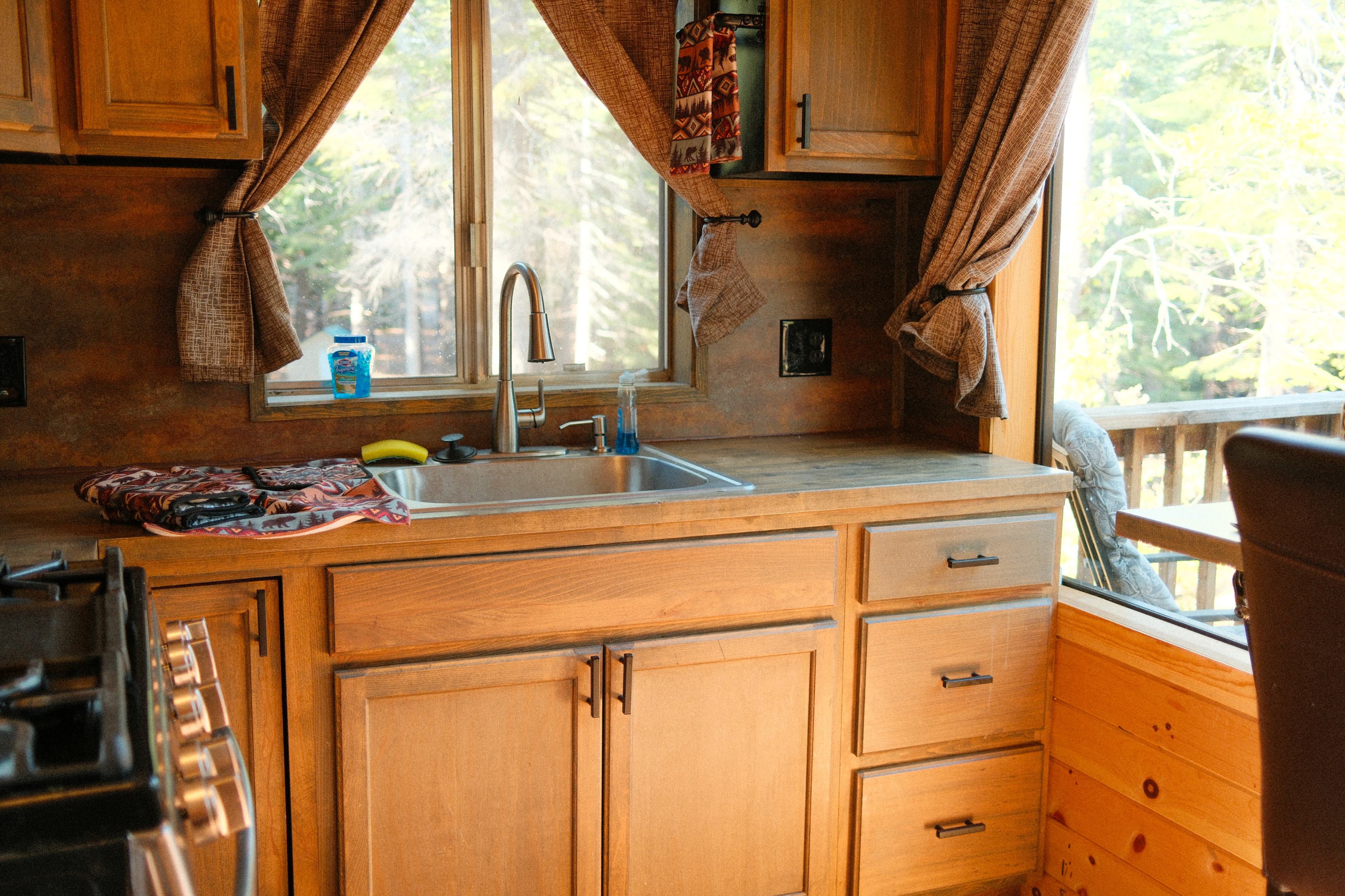 The cabin kitchen comes complete with a full range, microwave, sink, pots and pans, and utensils for cooking