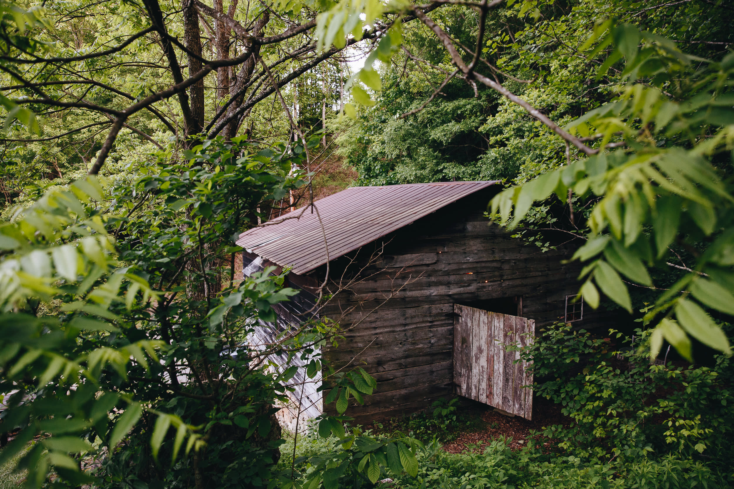 Front door tucked on the backside of the tobacco barn.