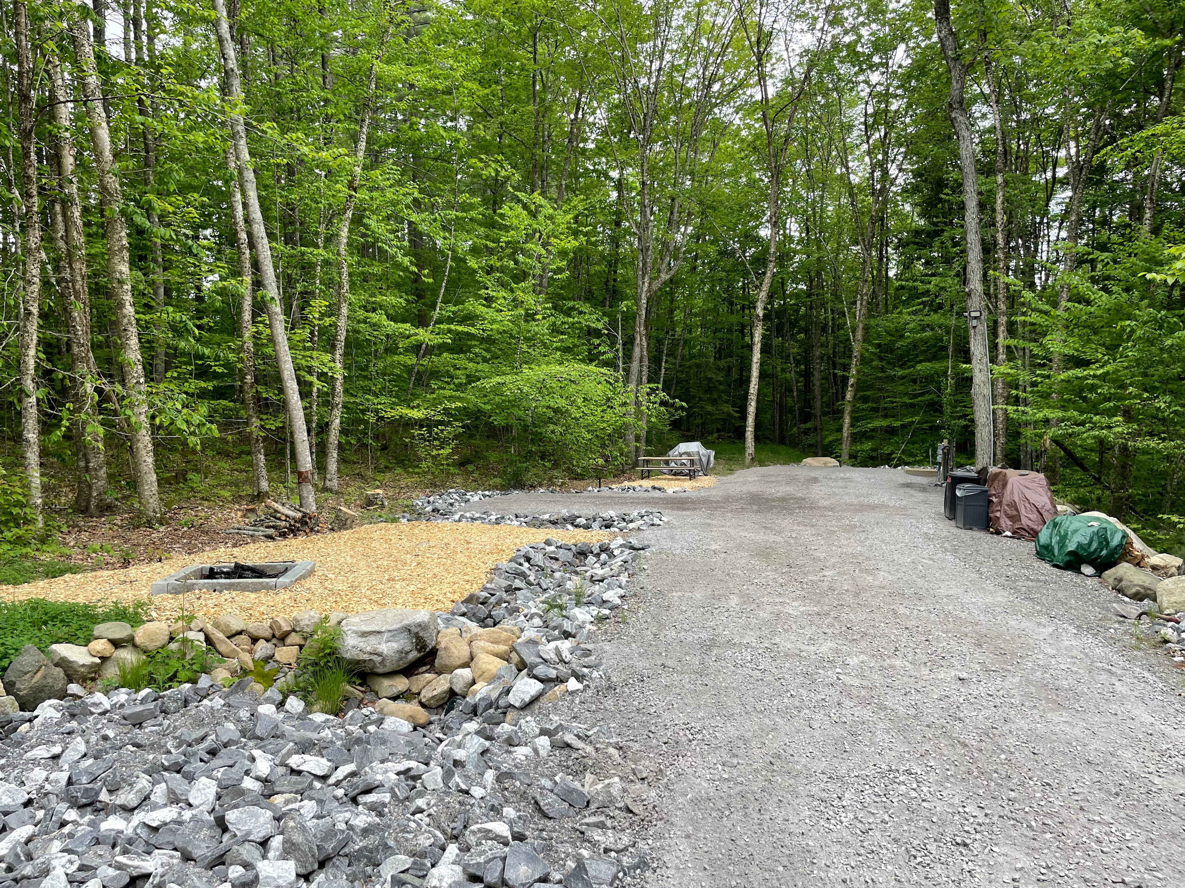 There are two pads at the end of the driveway.  On the RV pad is the potable water, outdoor shower, and electrical, blackwater & grey hookups.