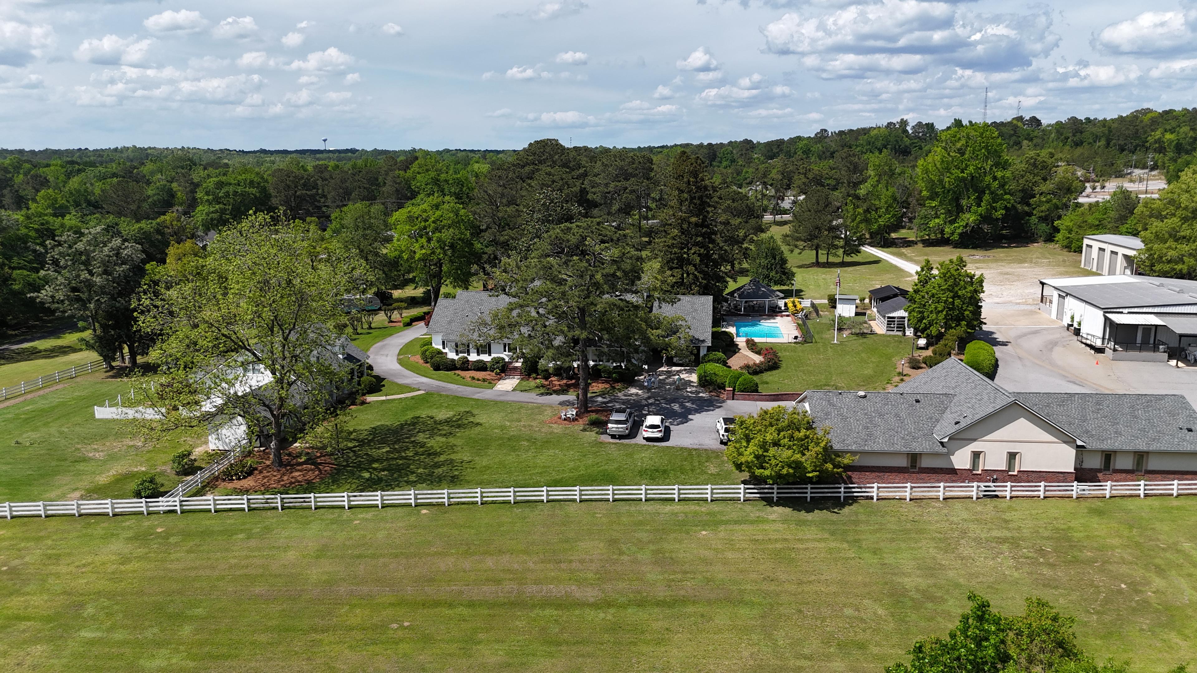 Come Glamping with us. Our property has a shared pool w/ a gazebo that has outdoor dinning & grilling area. You will be nestled close to a creek, exquisite gardens, our muscadine vineyard, fruit trees & plush lawns. The trailer sleeping quarters includes a bedroom with a full-size bed, it also has a bunk bed with twin size beds for 2 children to sleep.  The kitchen has a microwave, range and refrigerator. 