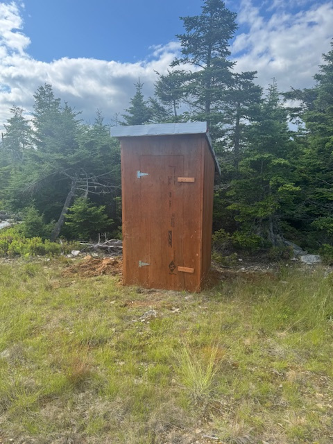 Basic outhouse, it has lights and a solar inverter for charging phones or small appliances. 