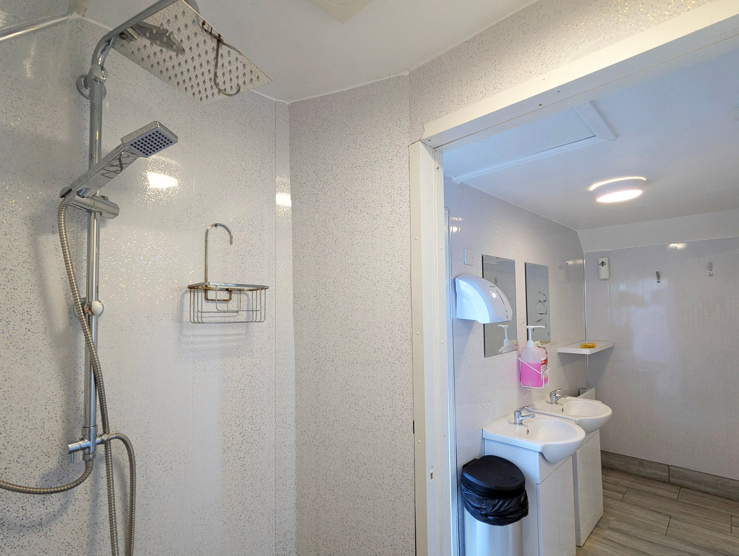 Ladies toilet block showing one of two showers with plenty of space for belongings