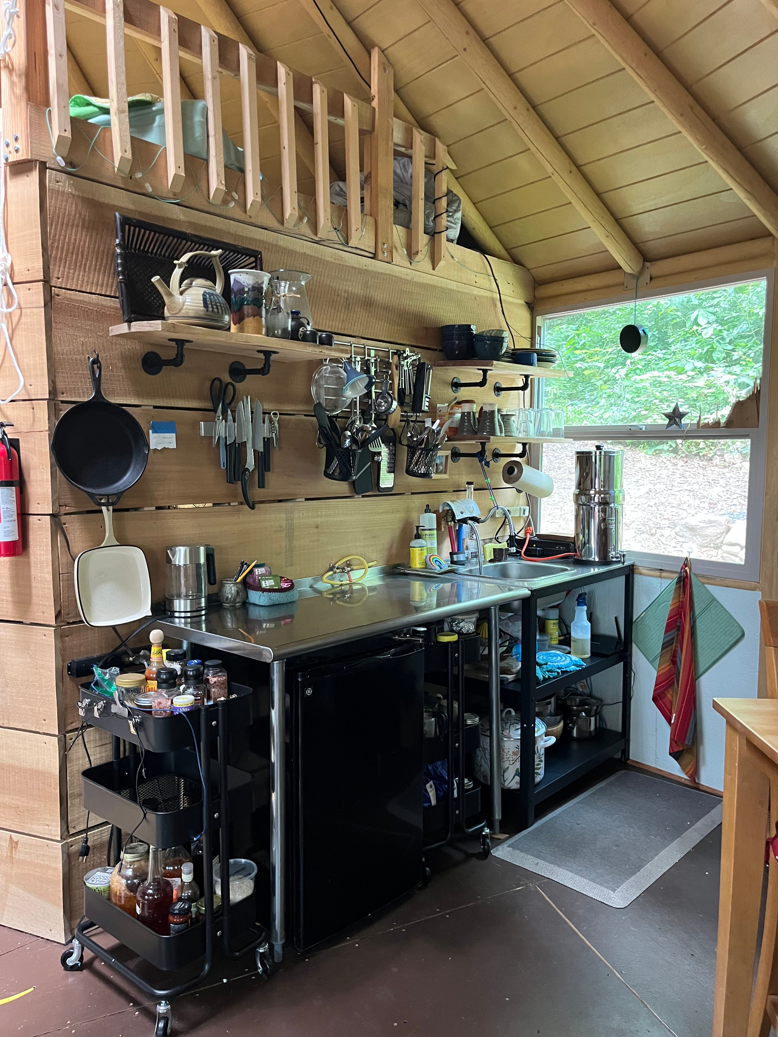 Kitchen area where you can prep food to cook on the outside grill (grill includes a burner to heat water/food).  Kitchen includes water kettle, cooking utensils, pots and pans, cutlery, dishware, tea/coffee trolley, spice trolley and Berkey water filtration dispenser.