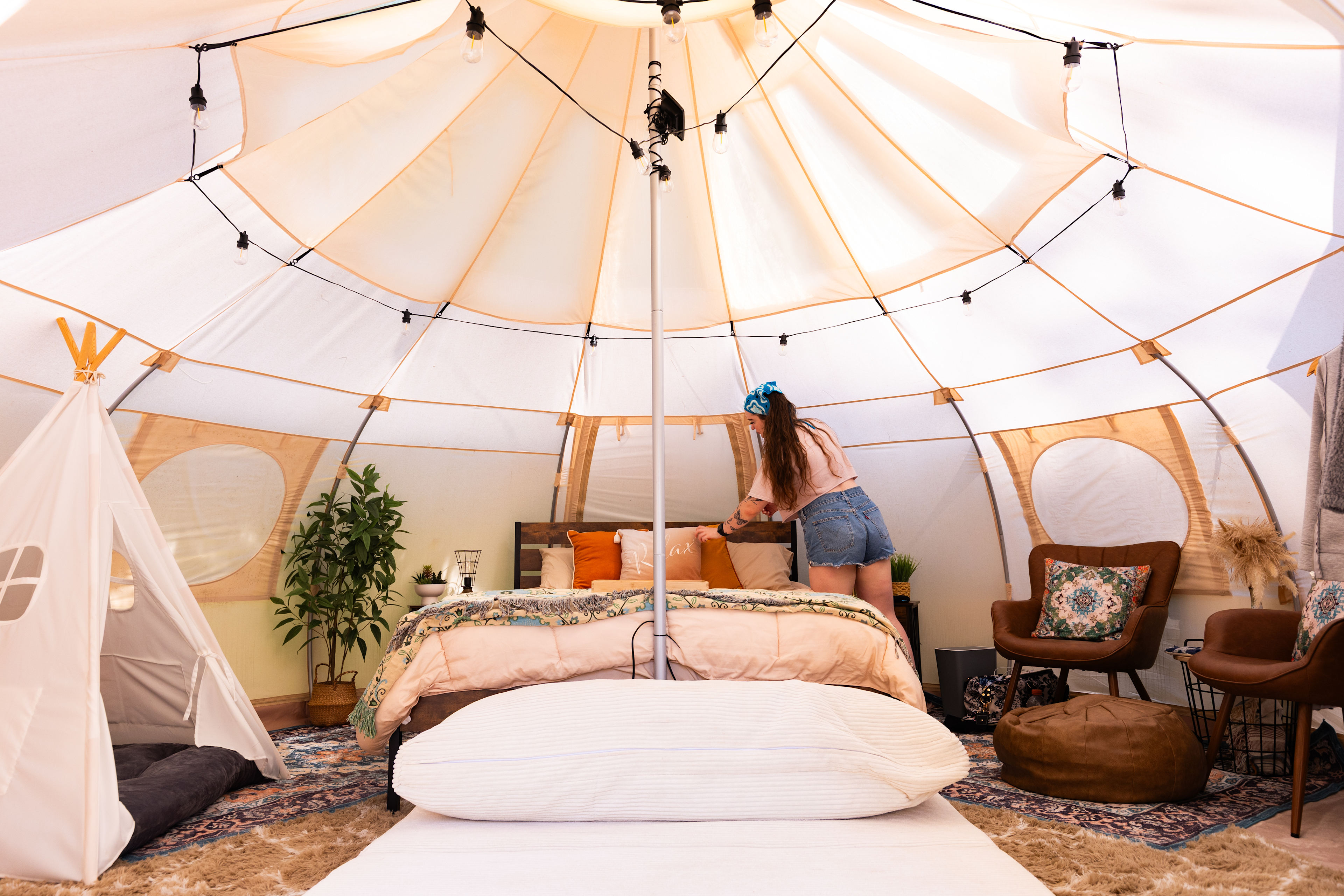 Interior of the tent, which includes the two beds, dog bed for the furry friends, and seating and storage options
