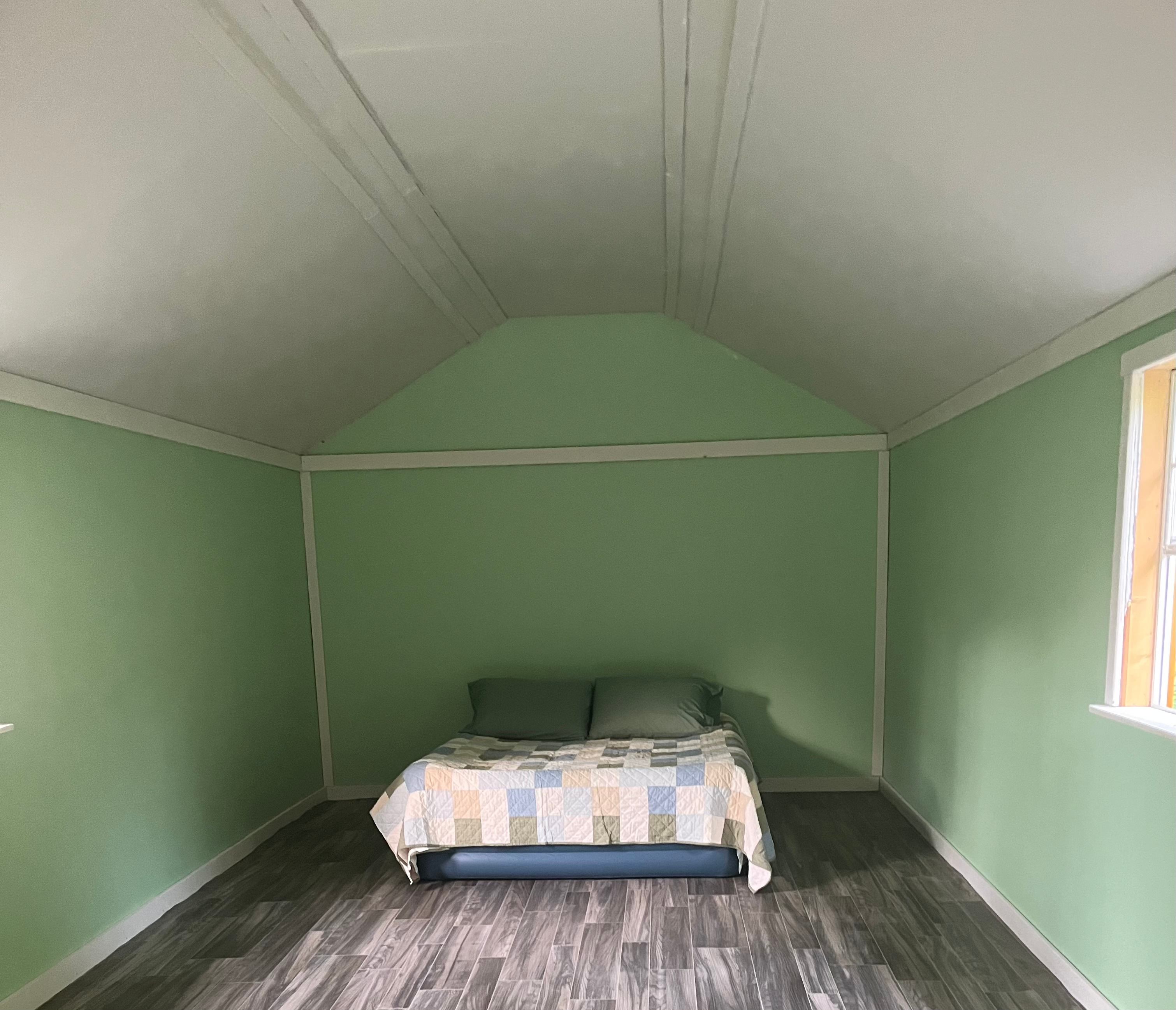 Large camp cabin can fit at least 2-3 queen size air mattresses, comes with folding tables, lamps and fans. 