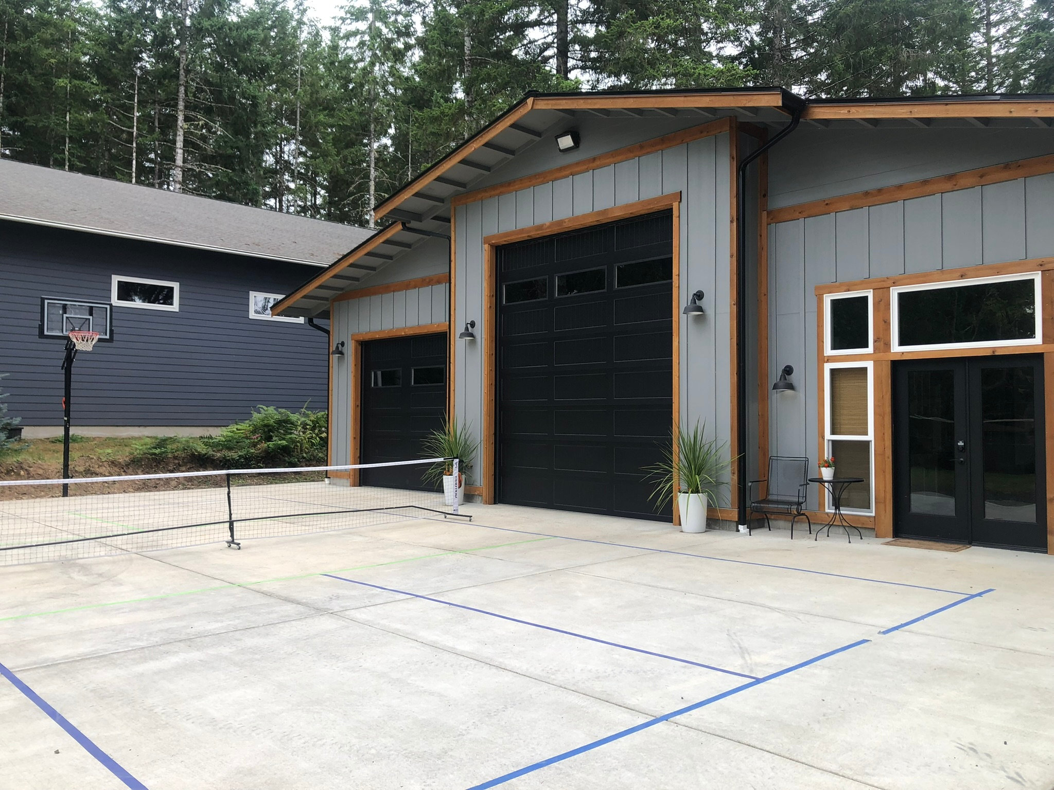 Sports court w/ basketball hoop and moveable pickleball net. **Do NOT drive or park on concrete**
