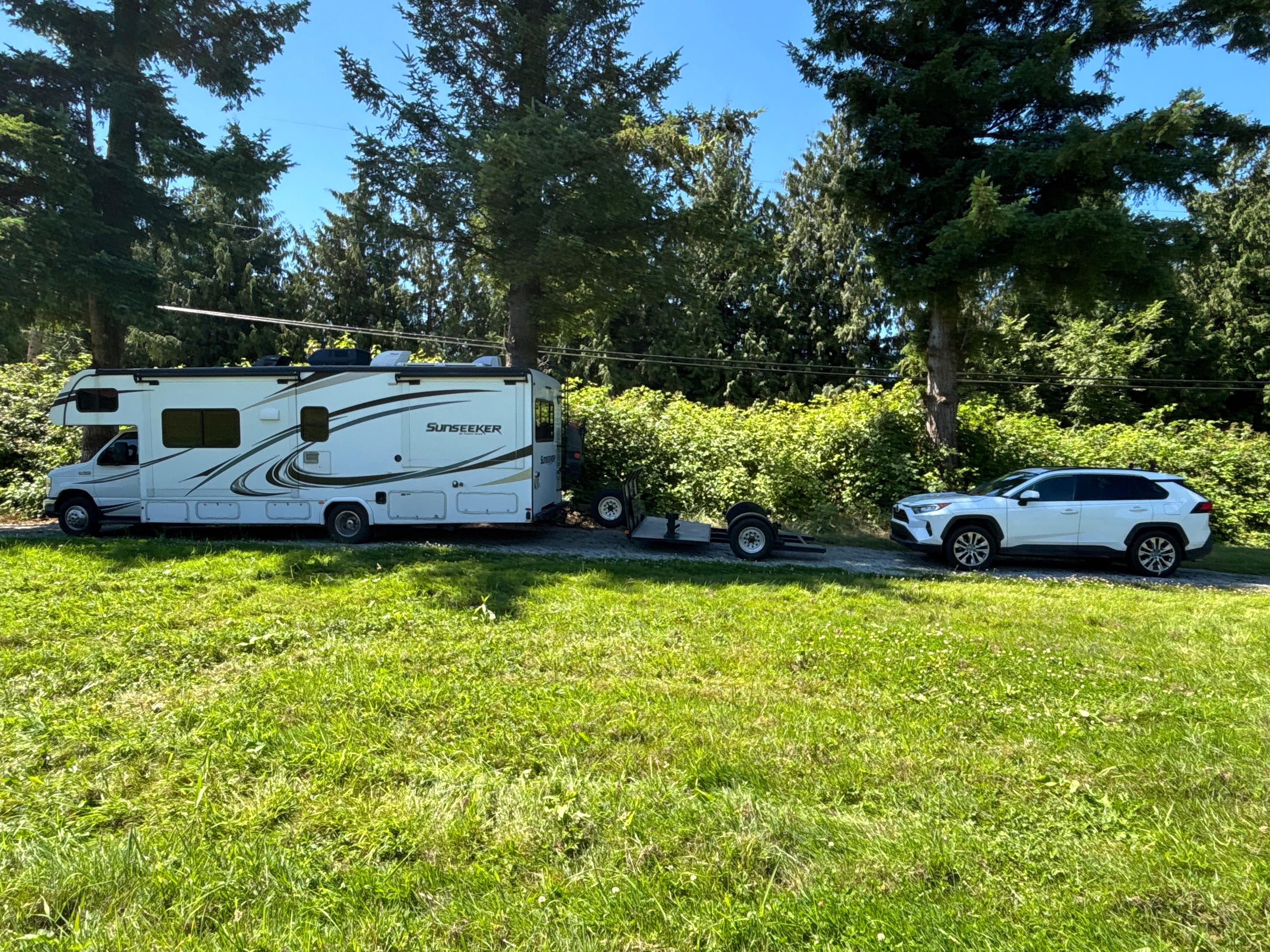 Parked on gravel by the blackberry bushed