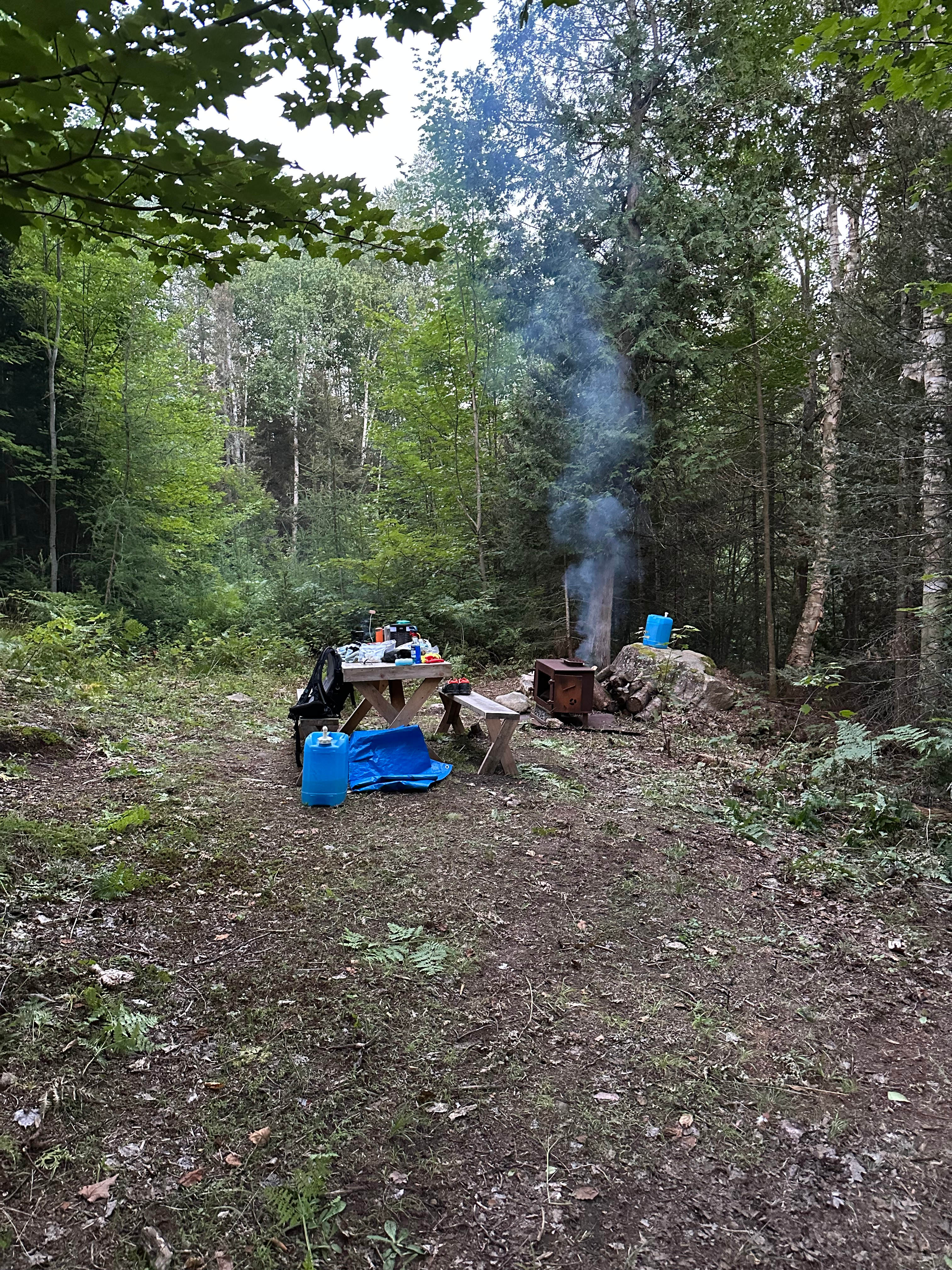 Setting up for dinner, fireplace, picnic table, drinking water and washing
