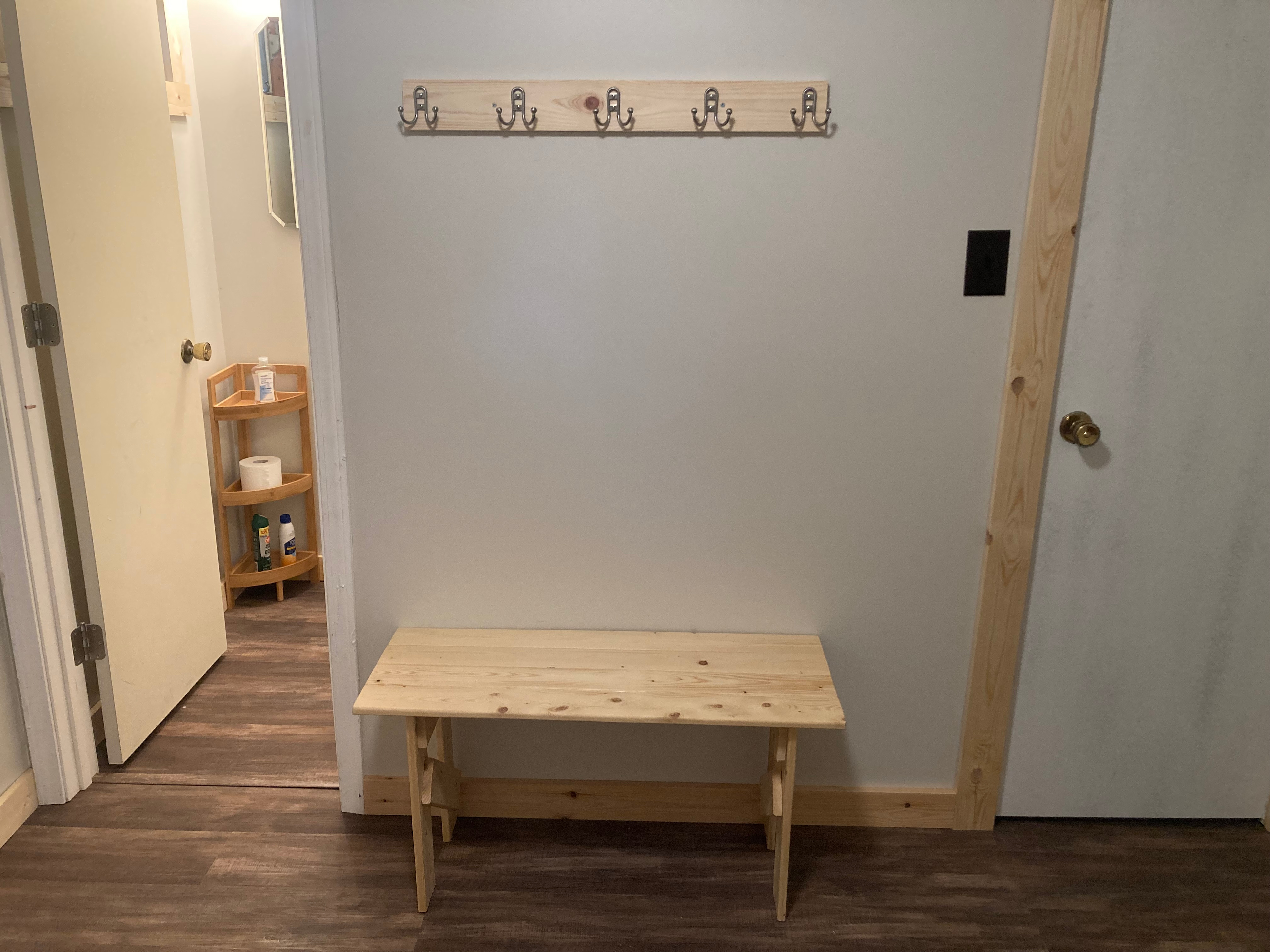 Hooks and a bench for storage. 