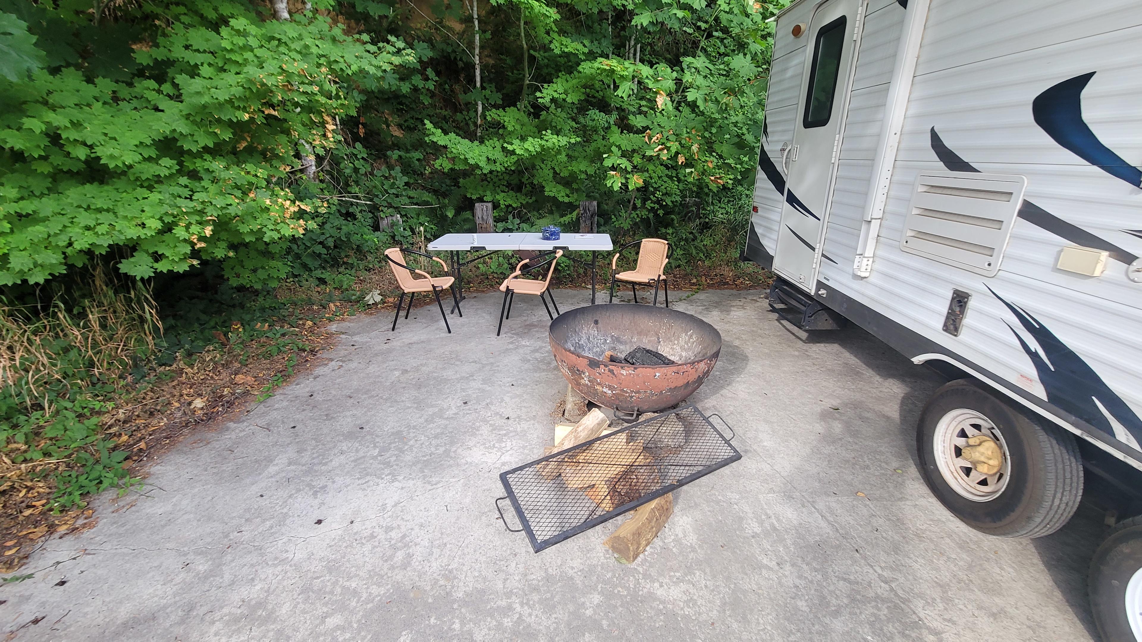 Table, chairs and fire pit, even some wood