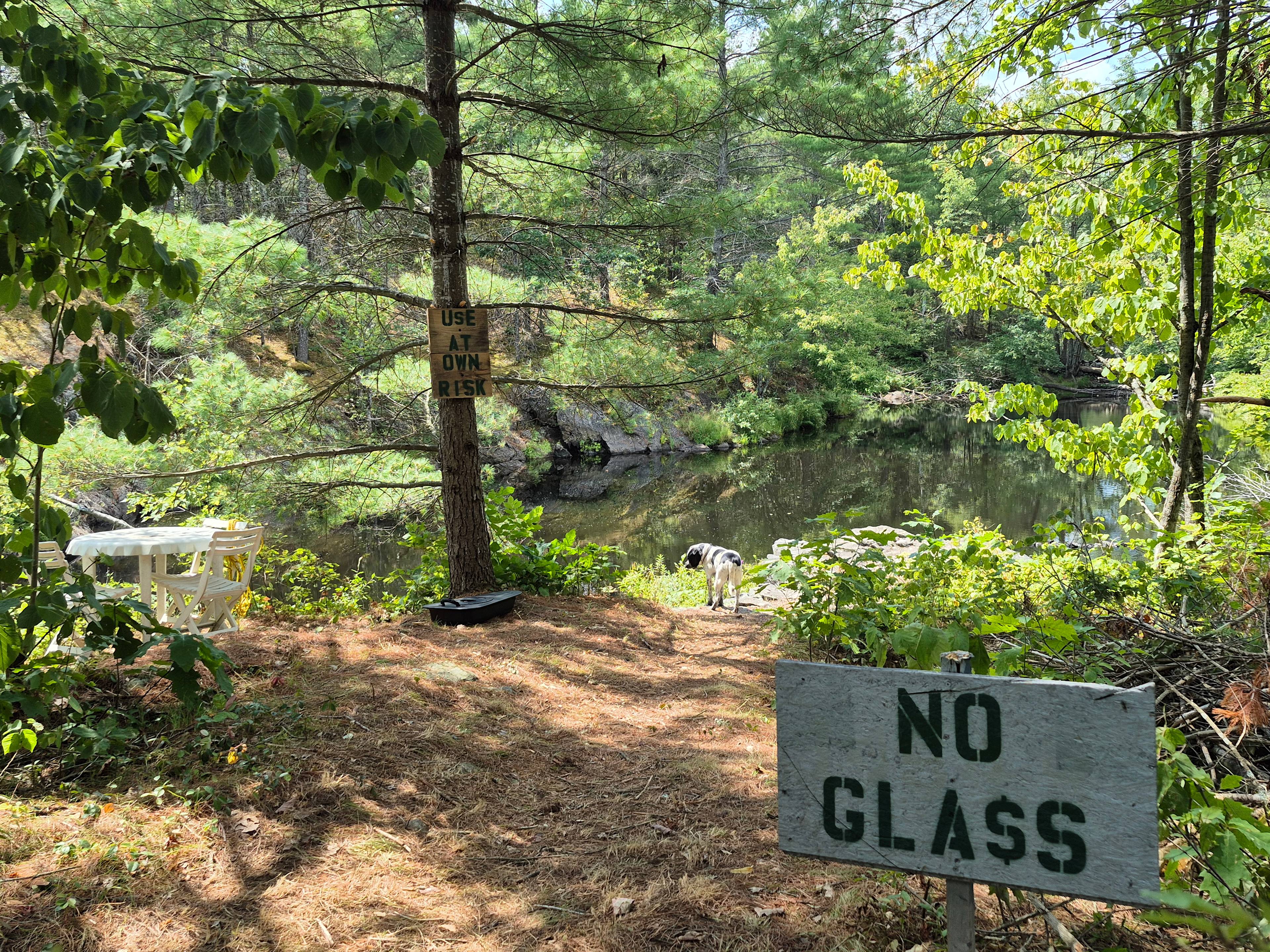 Local swimhole, trail to it is at the yellow bridge. Use at own risk, outdoor toilet, table/chairs and safety throw rope on site. No Glass 