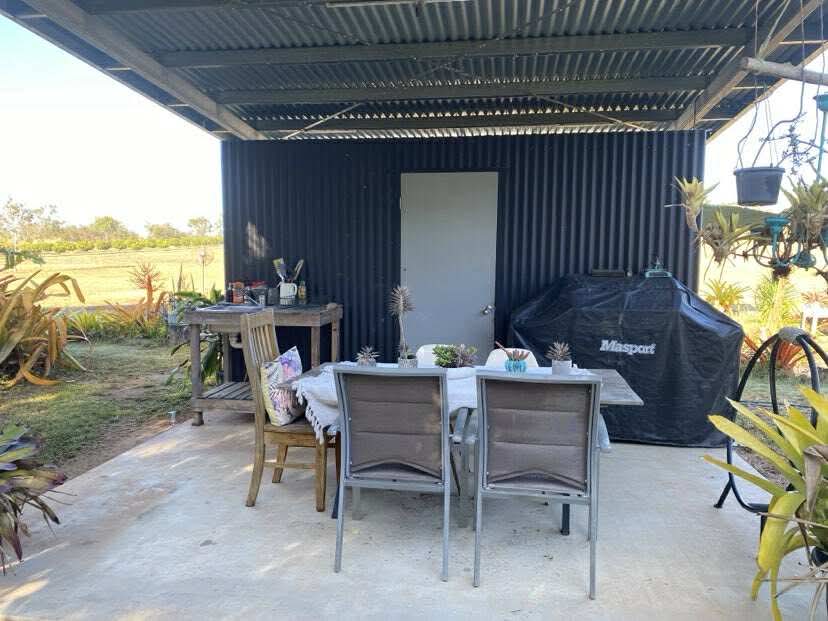 Out door Bush kitchen with BBQ and sitting area . 