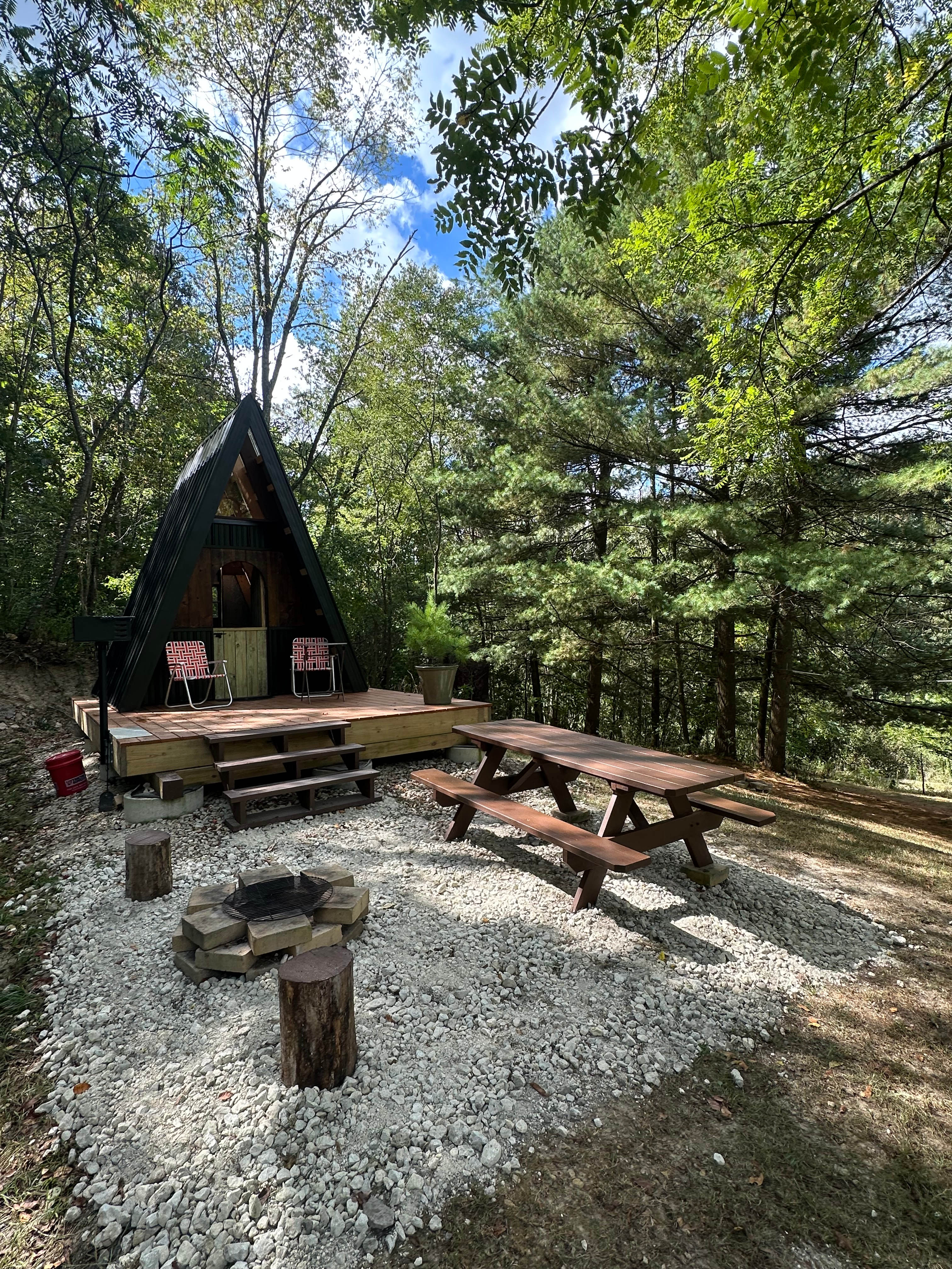 Small fire pit with cooking grate in addition to state park style grill on deck. Picnic table as well.