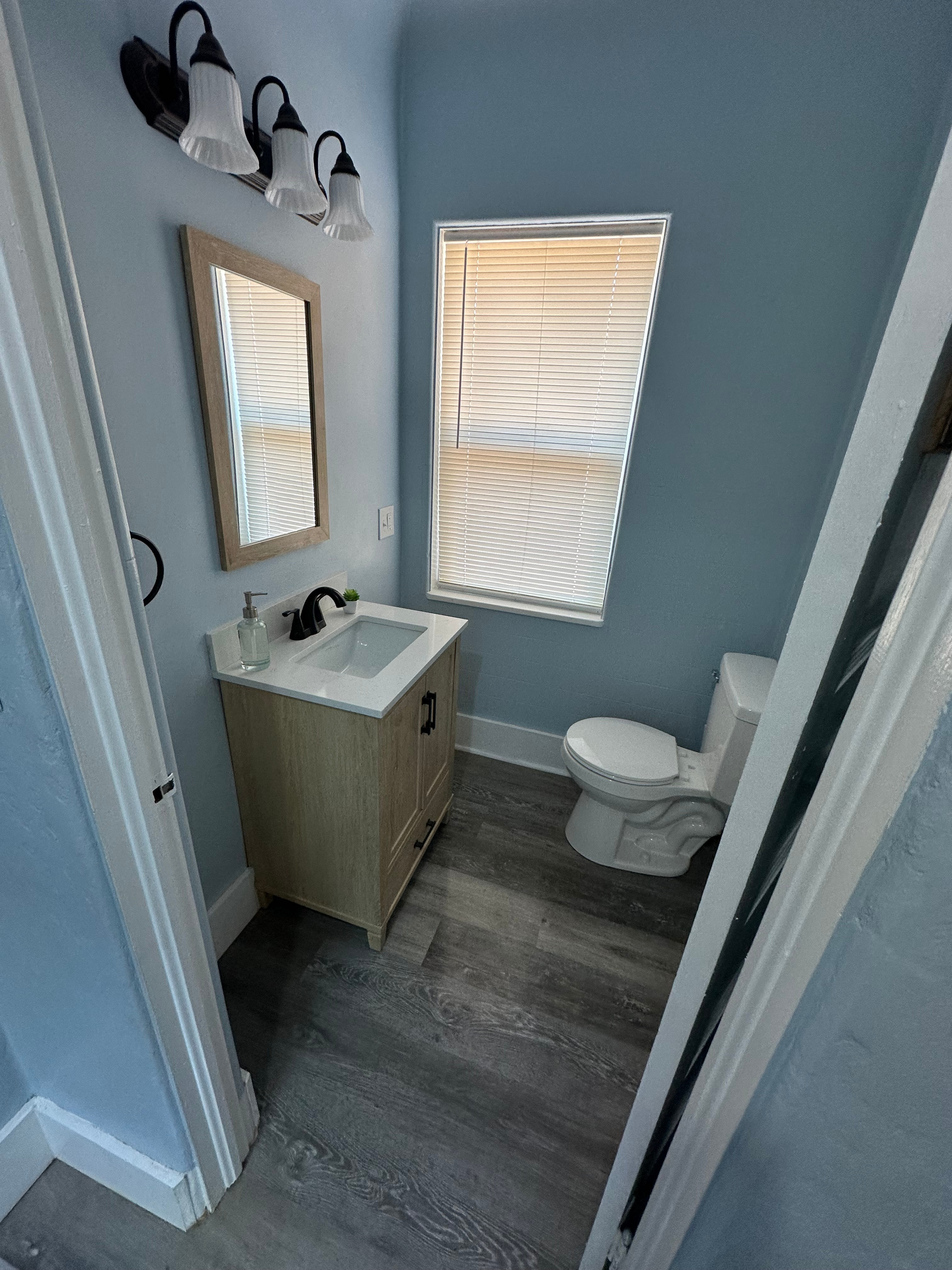 This is a half-bath with newly installed cabinet, mirror, and light fixtures.  Hand towels and hand soap are provided.  Cleaning supplies are also onsite in case they are needed during your stay.  