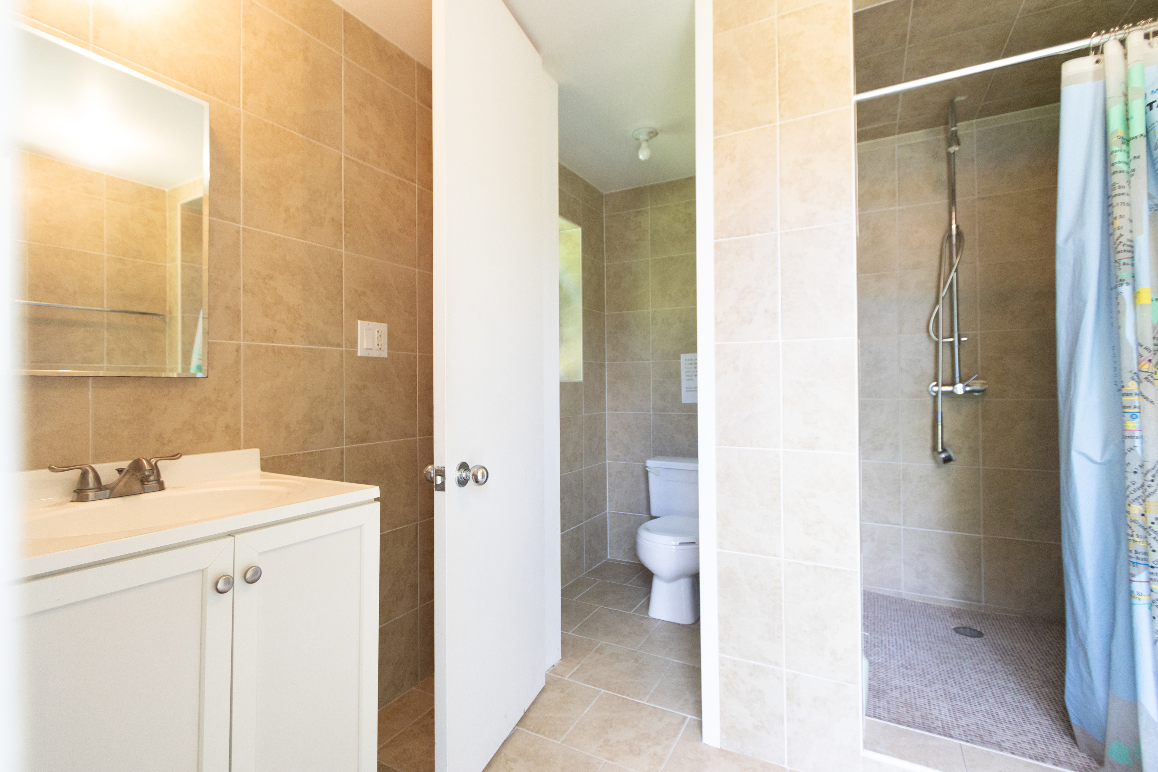 A full bath with a bathroom and shower