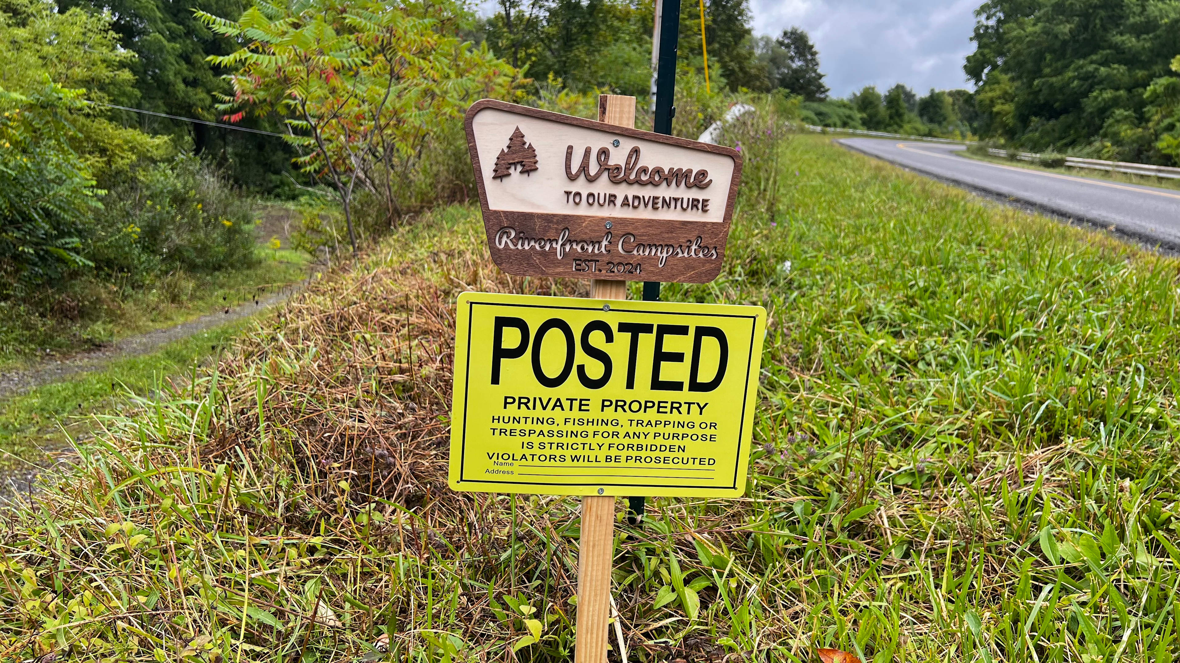 Signs at the hidden driveway.