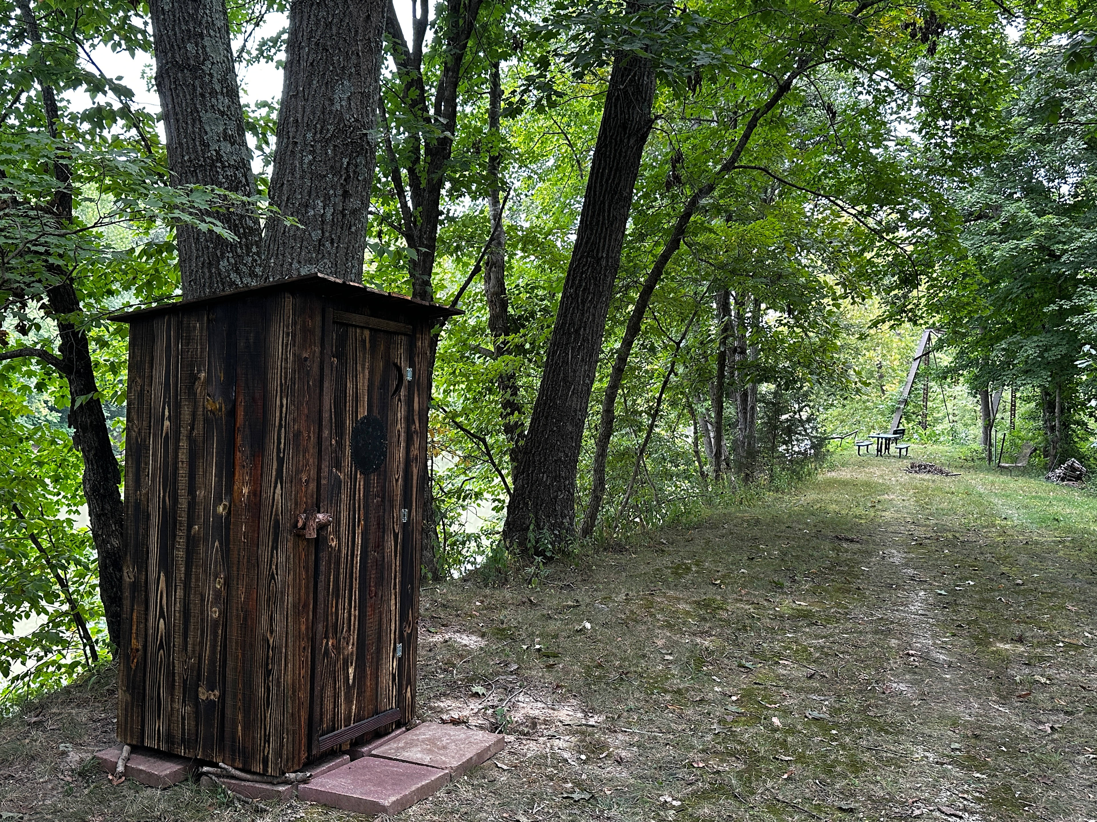 Just getting this new outhouse level and ready as of August 31, 2025. It's got an antique commode chair with a recyclable plastic bag in a ceramic coated bucket hidden under the seat. Of course some folks choose to bring their own portable camp toilet.