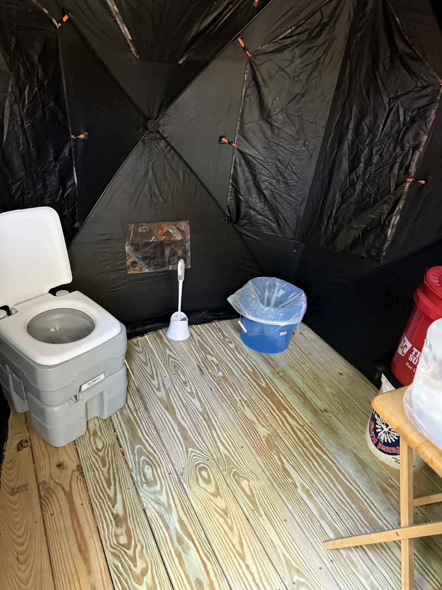 Approximately 6x6’ primitive bathroom tall enough to walk in with fold down flaps and one way viewing screens for privacy. Water jug, toilet paper, and wipes are on hand.