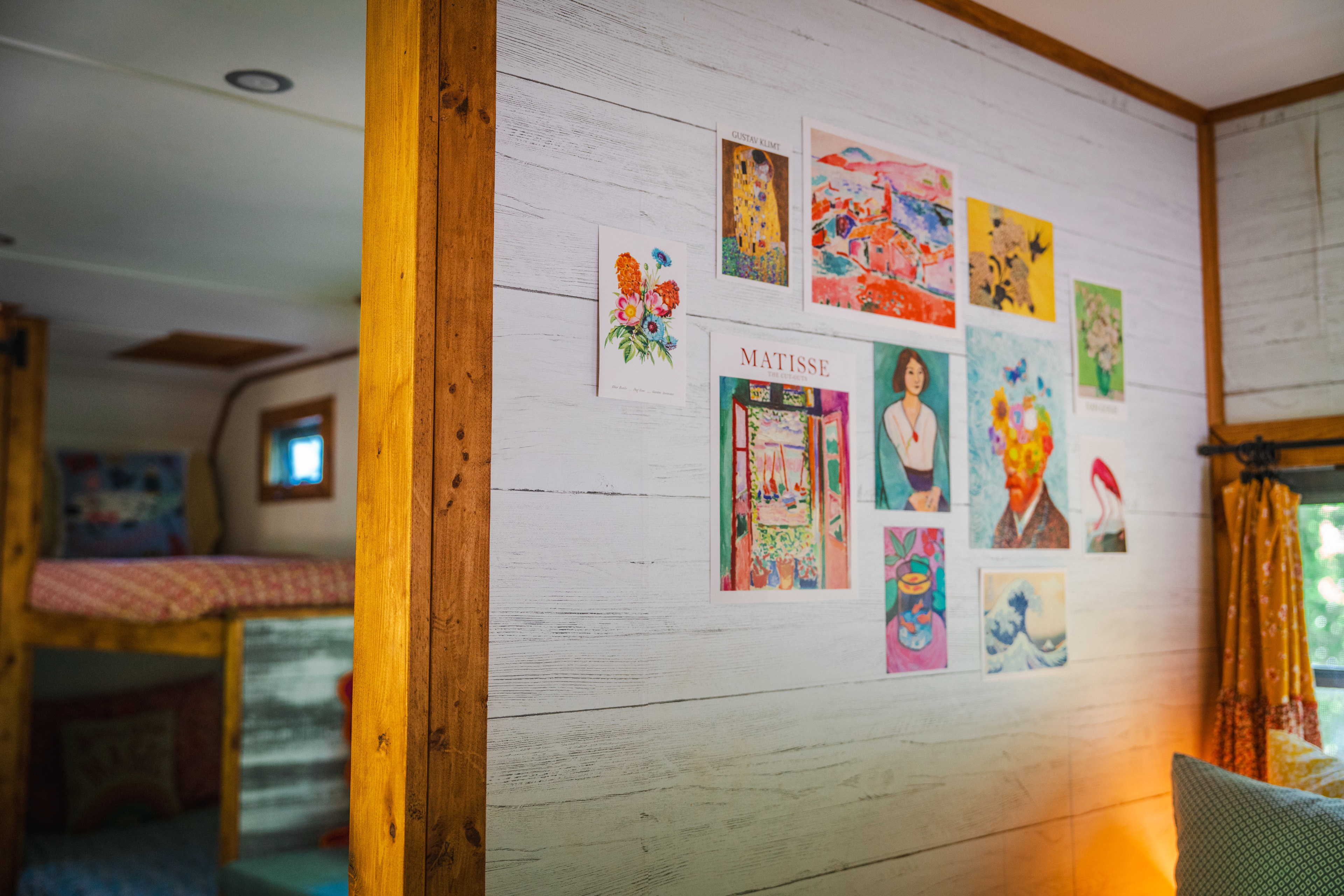 colorful, decorative art wall next to bed