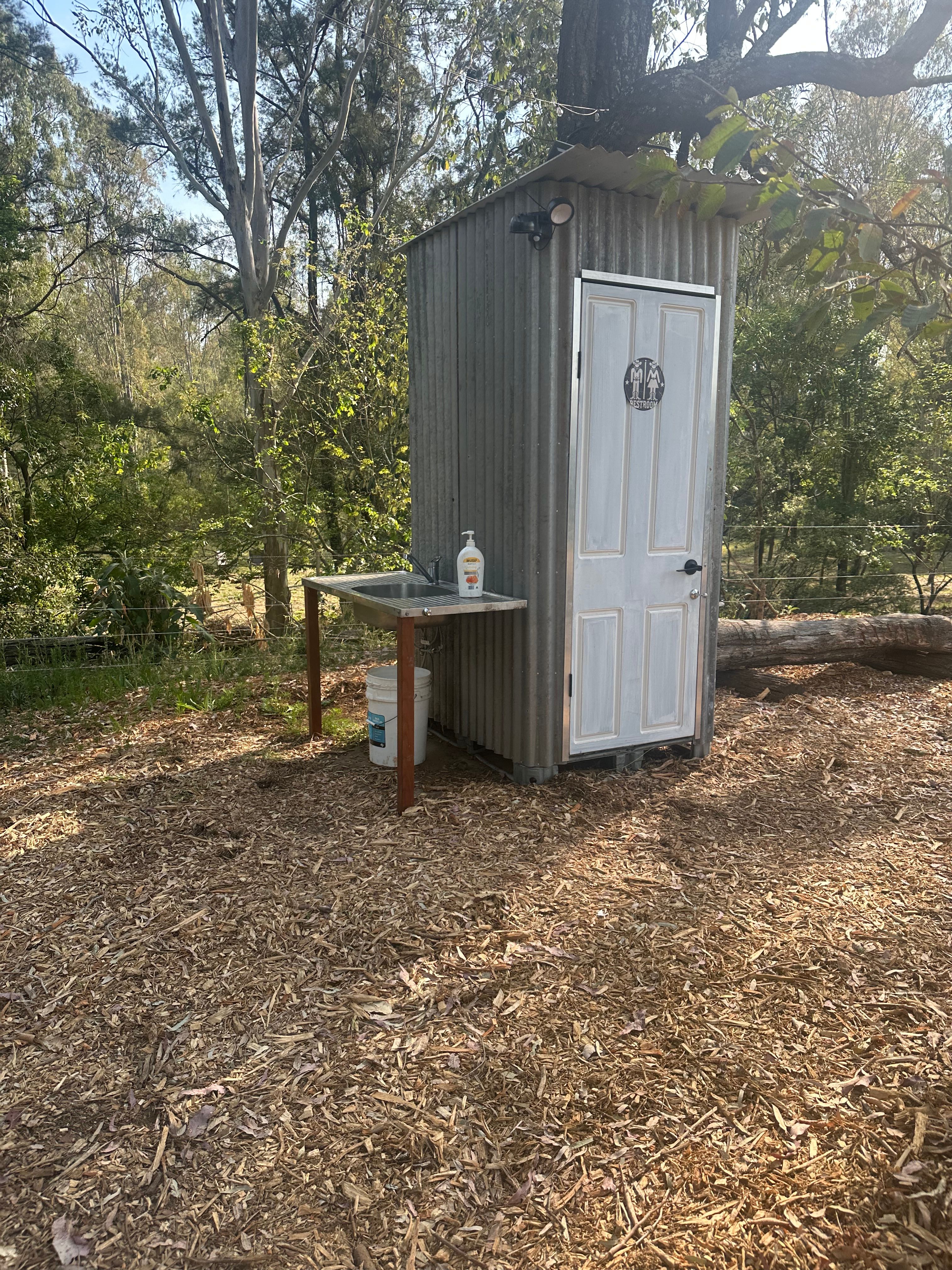 Don’t let the outside tin walls fool you - inside is complete with nice flooring and cute decor touches and plant. So well thought through
