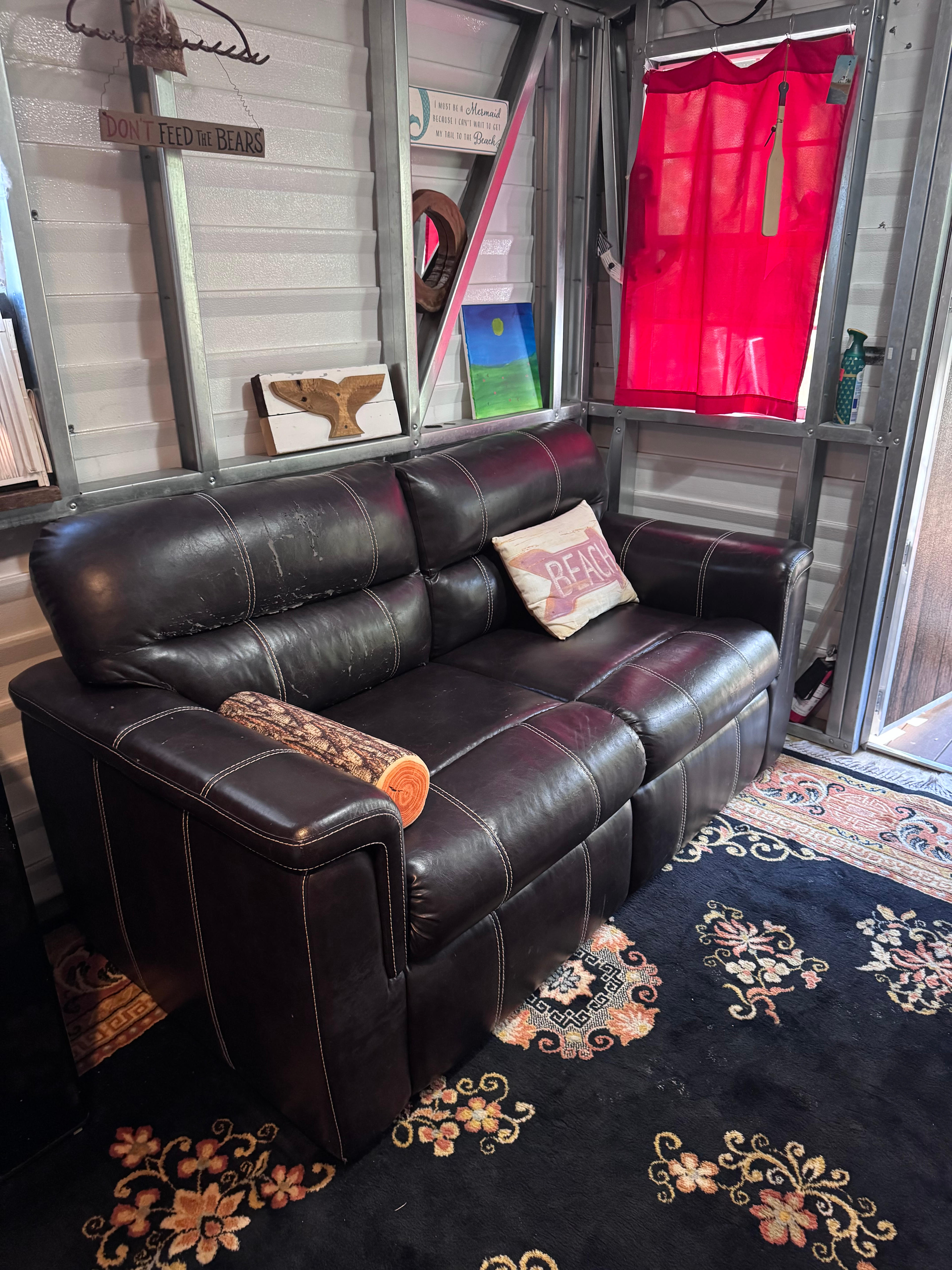 Pull out couch inside the cabin to enjoy by the inside electric fireplace, or pullout for an additional full-sized bed.