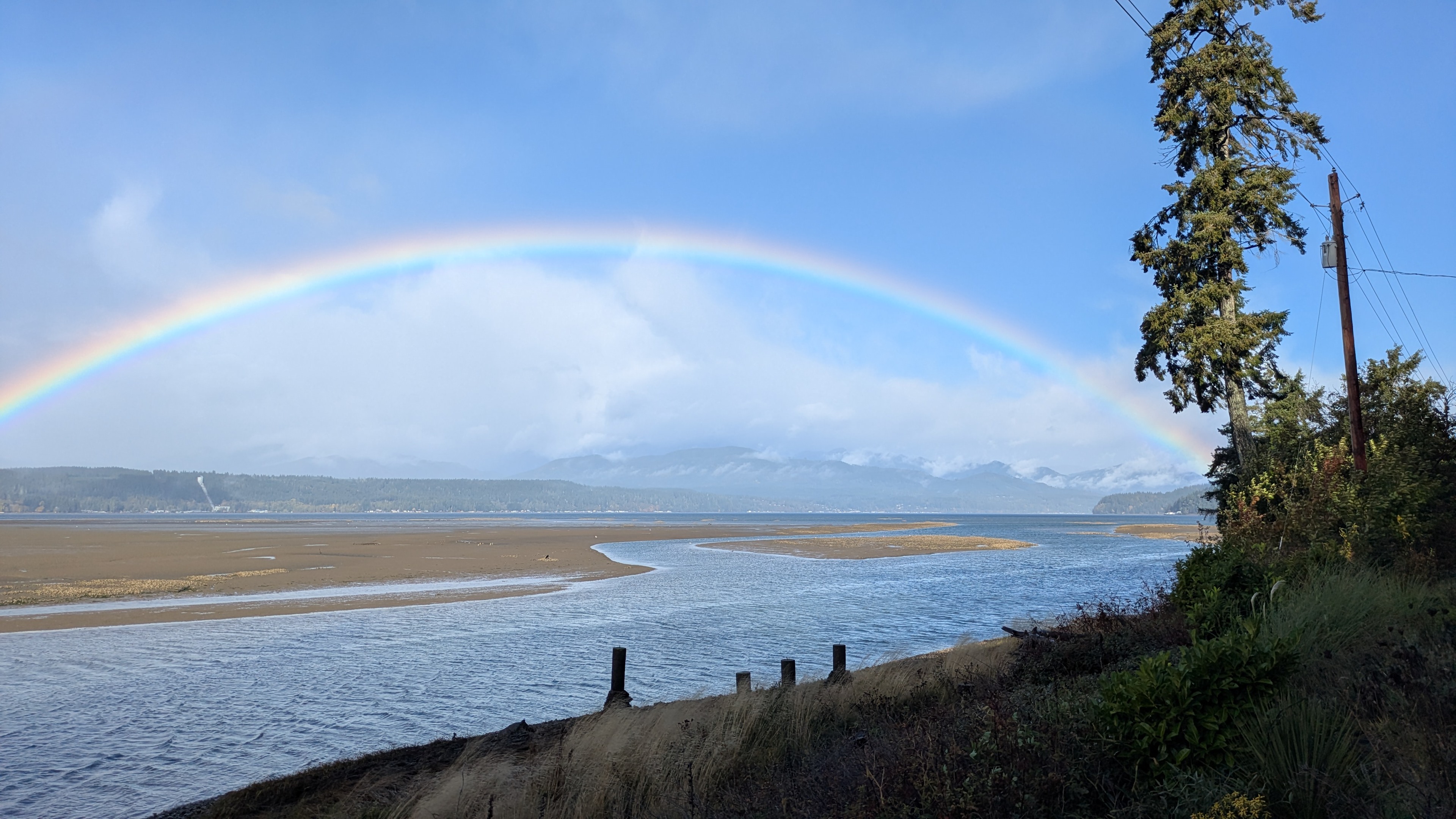 The morning fog and rain clears, revealing a beautiful rainbow across the Hood Canal