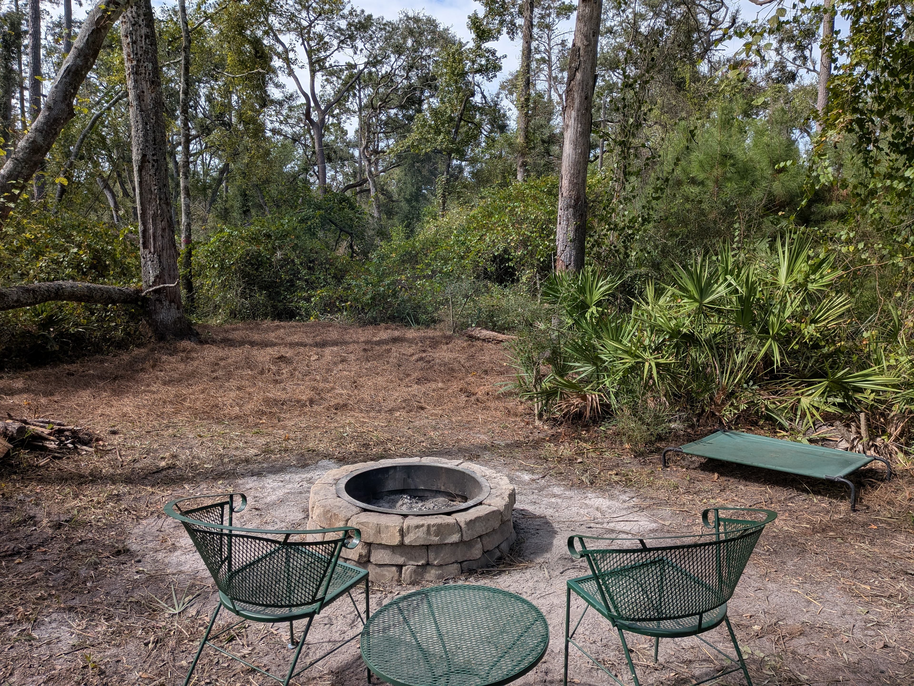 There is a fire pit, table and chairs, and a dog hammock provided. 