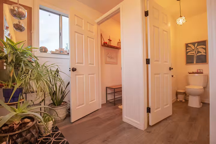 Shared bathhouse with two showers and two toilette stalls.