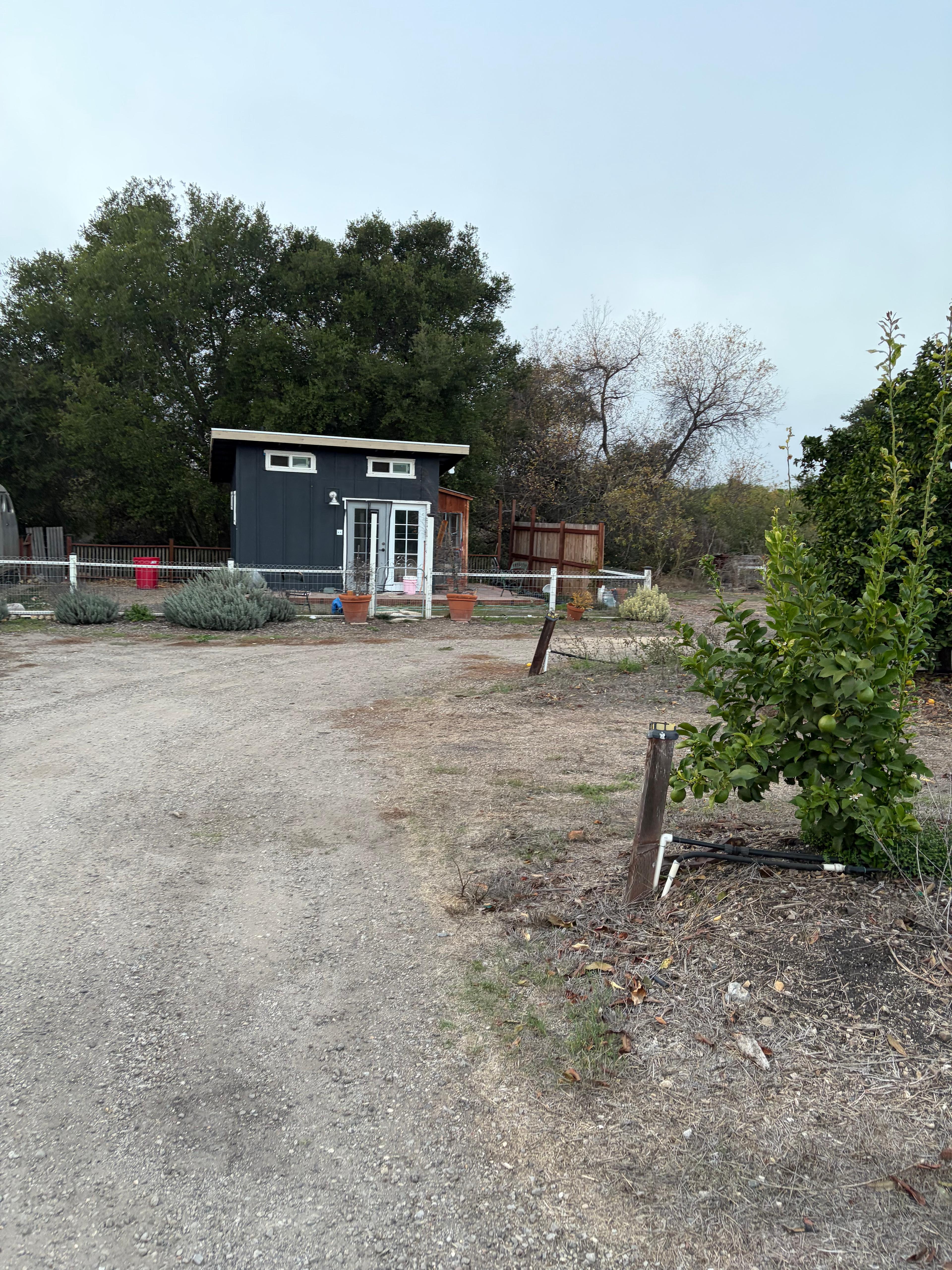 Proceed til you see this building. This houses the toilet, and washer dryer, as well as where guests are able use the outdoor, hot-water shower (right