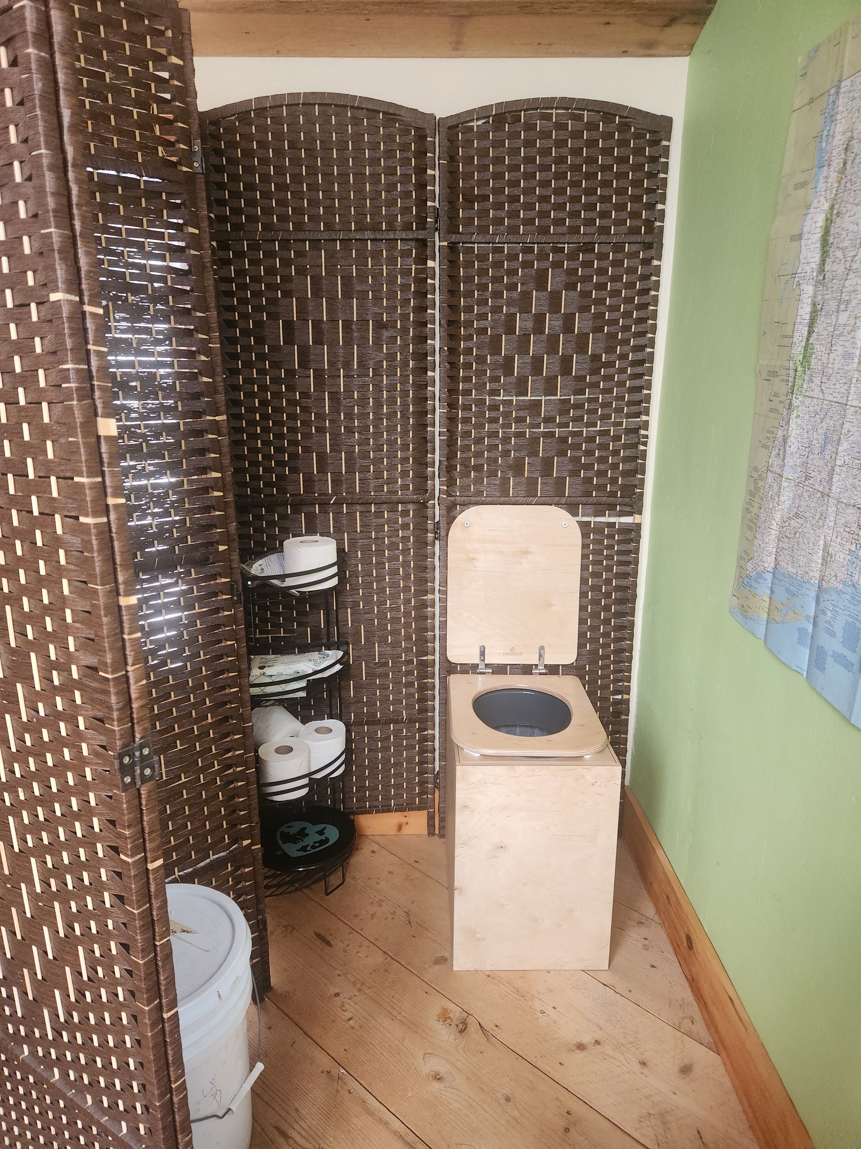 At the top of the stairs you will find the composting toilet.  To the right of the toilet there is a writing desk that looks out onto our pond.