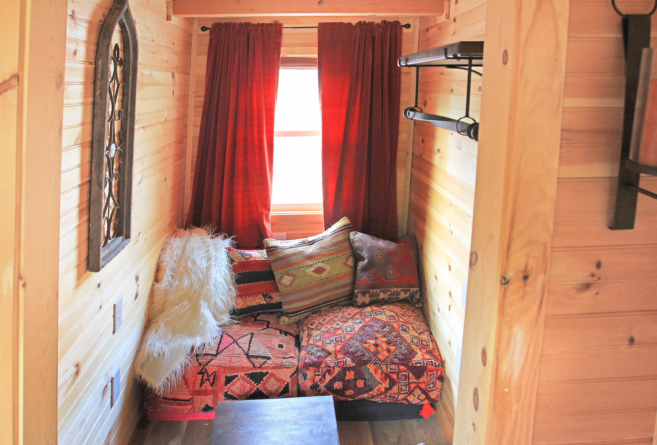Relax in a Boho-designed sitting area with antique Moroccan poofs, kilim pillows and a cozy throw blanket. 