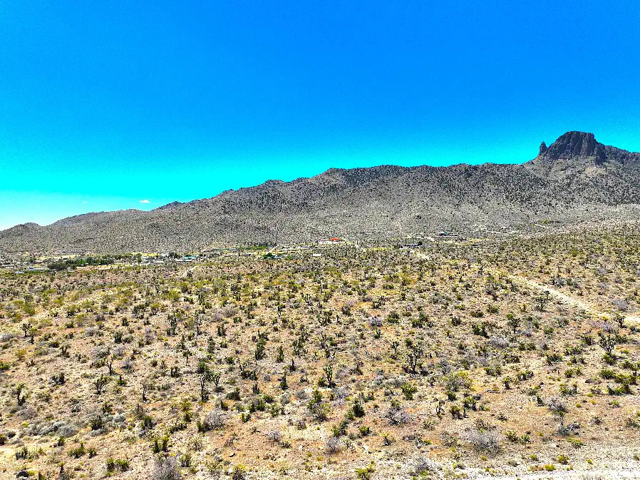 The 5 acres is flat land, but it’s very close to hiking and approximately 15 miles to Lake Mohave