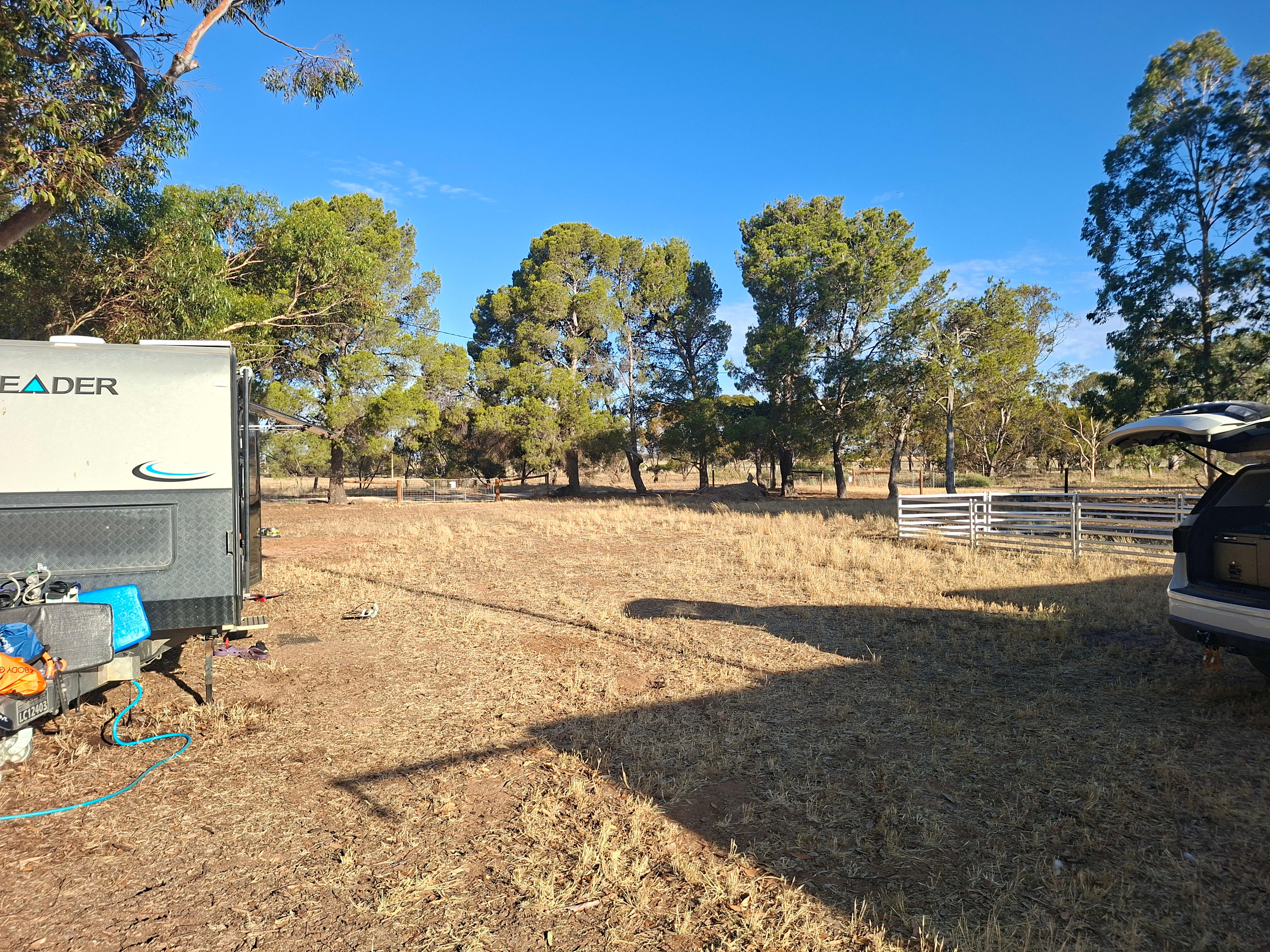There is ample turning space. 
This site can comfortably fit 6 large vans and their towing vehicle.
