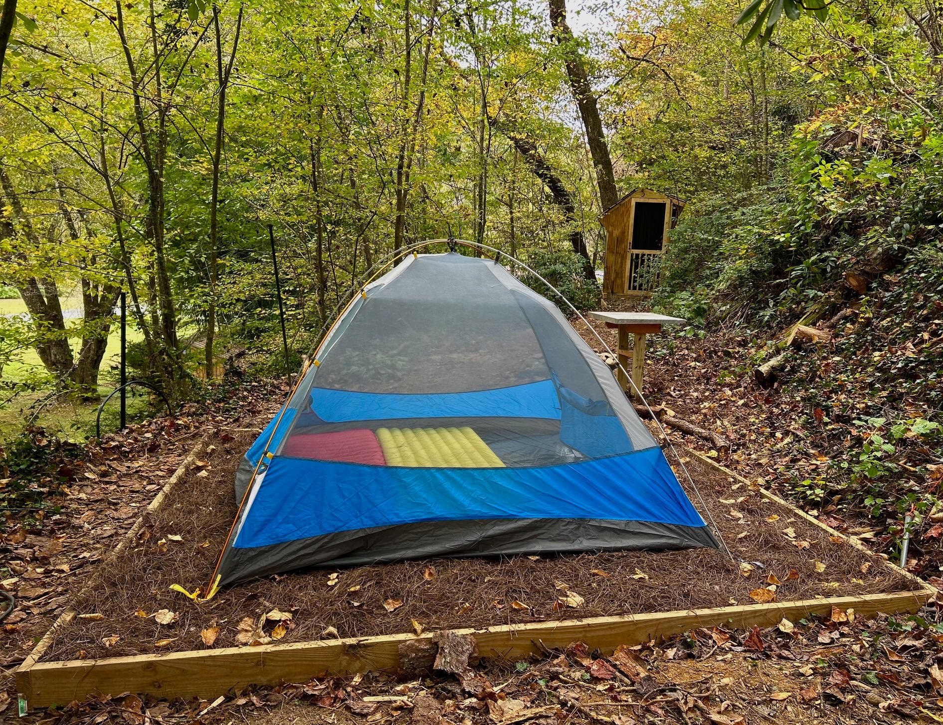 A 3-person tent is shown in this photo of the 10 X 10 tent pad. (Guests are expected to bring their own tent and gear)