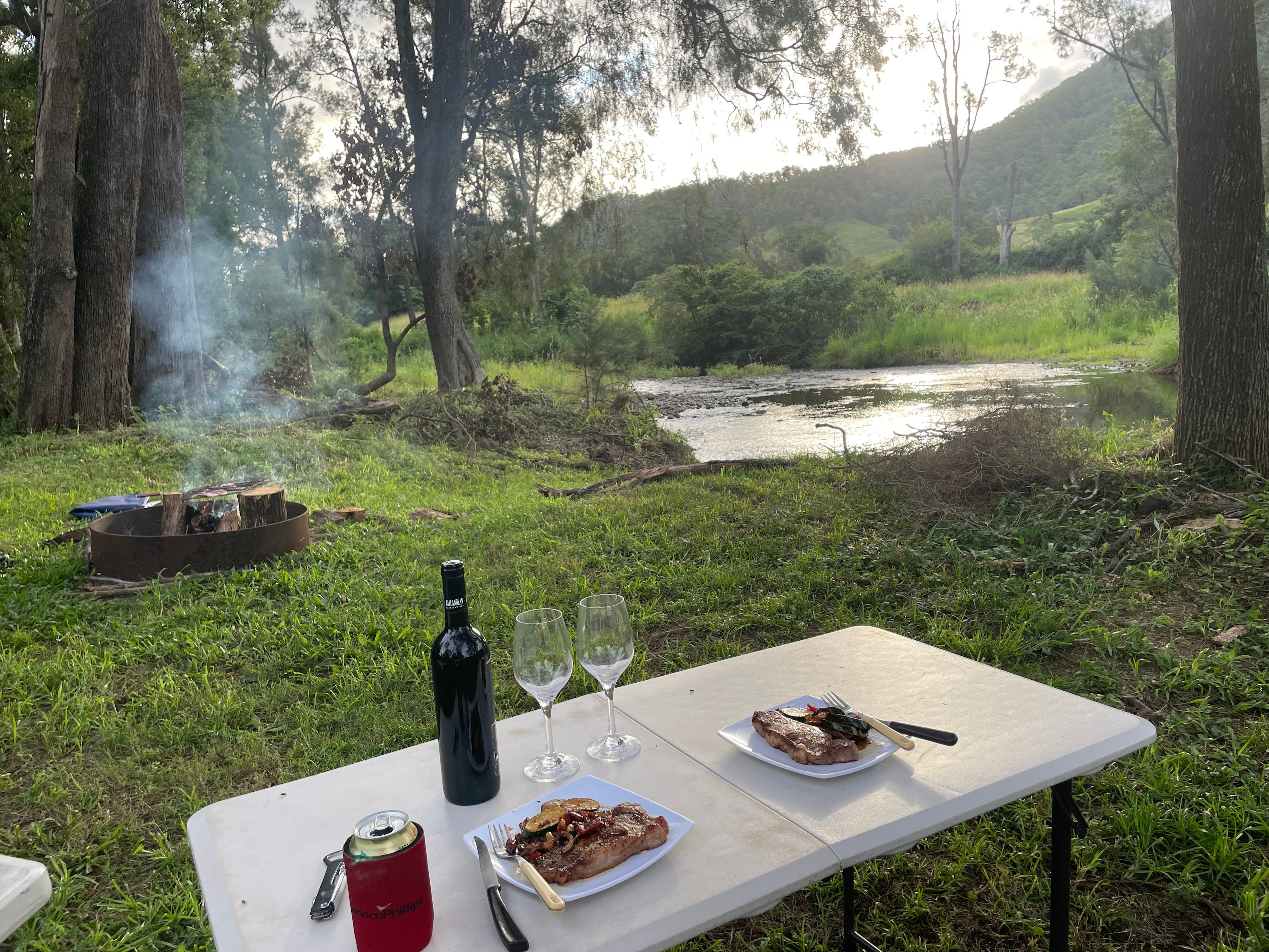 Dinner time watching the sun set over the softly babbling creek. Nothing like a campfire grilled steak!
