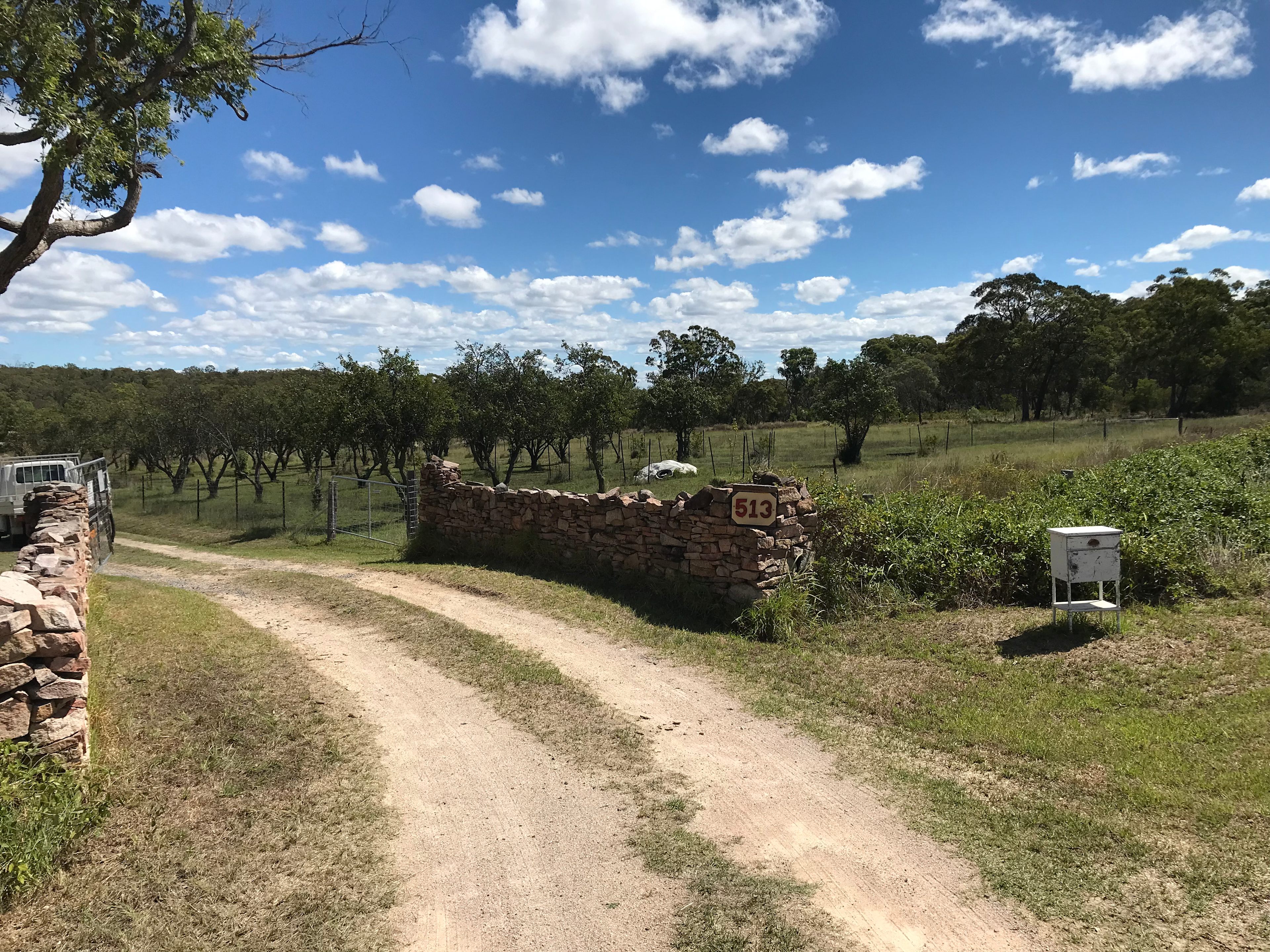Stonewalled entrance and gate  to Best Block Friendly Fruit Art Farm. 
Just follow the driveway down the gently sloping hill. 