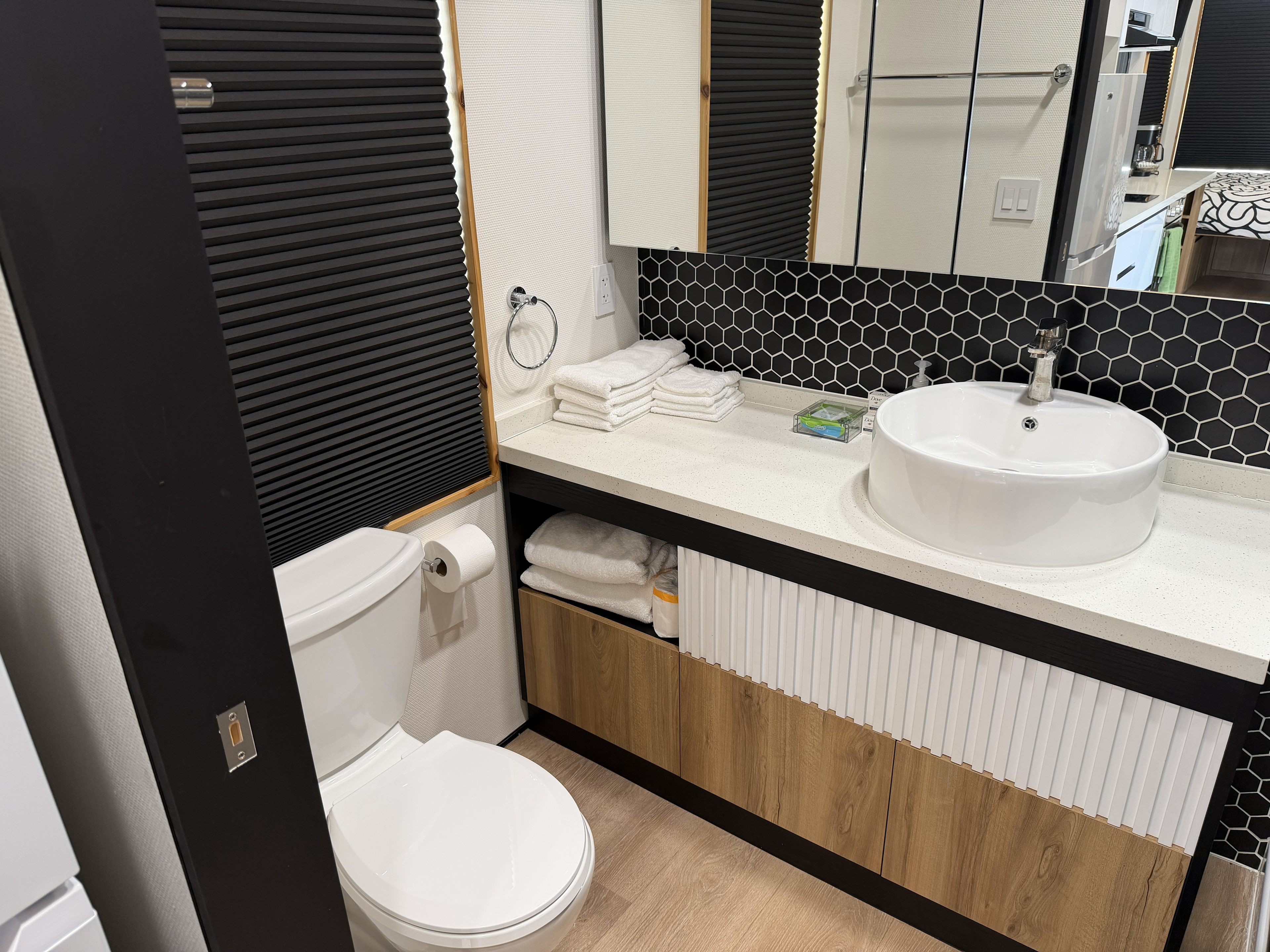 Full bathroom with toilet, sink, shower with hot water and towels provided