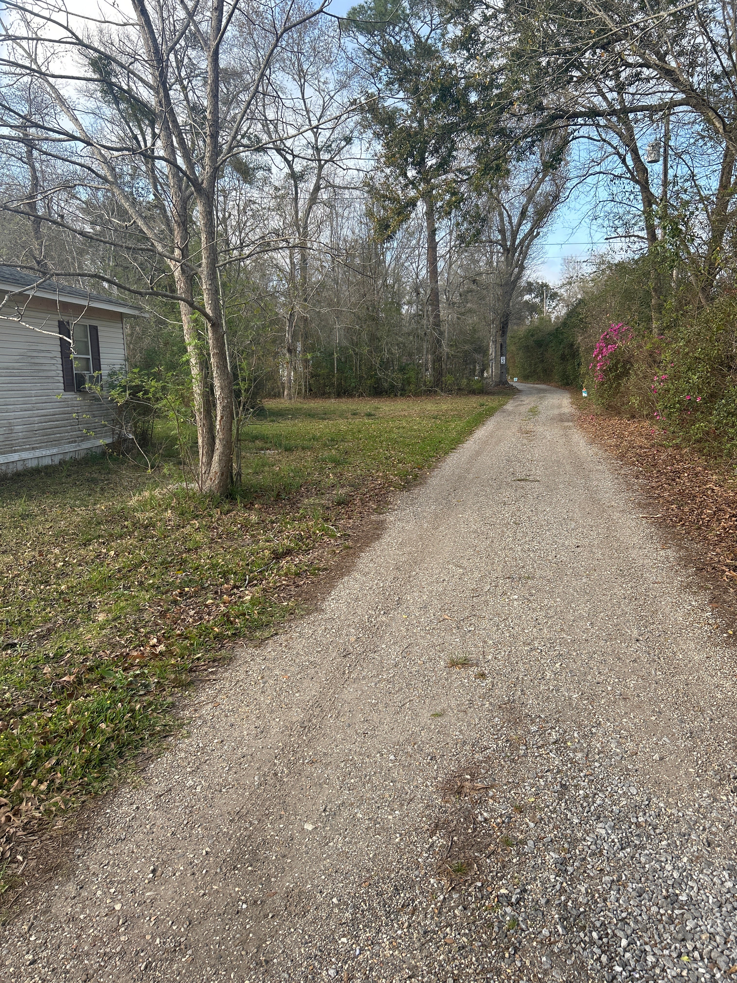 House on left side of driveway is neighbors property. Drive past to see gravel one-way loop. Pass 2 tiny homes to 2 RV sites on west side of property
